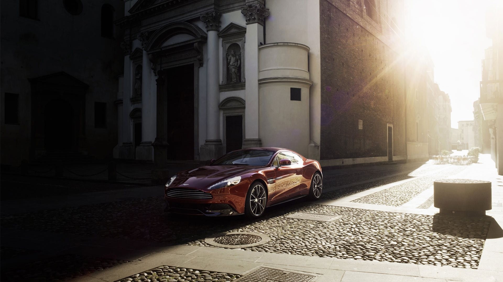 Aston Martin Vanquish on a cobblestone street HD Wallpaper