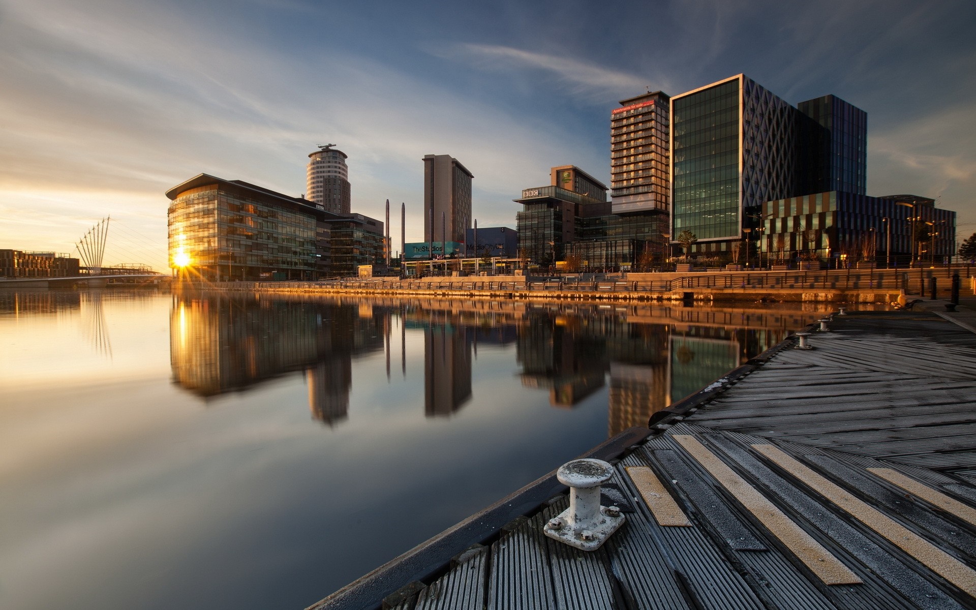 Cityscape with skyscrapers and water at sunset HD Wallpaper