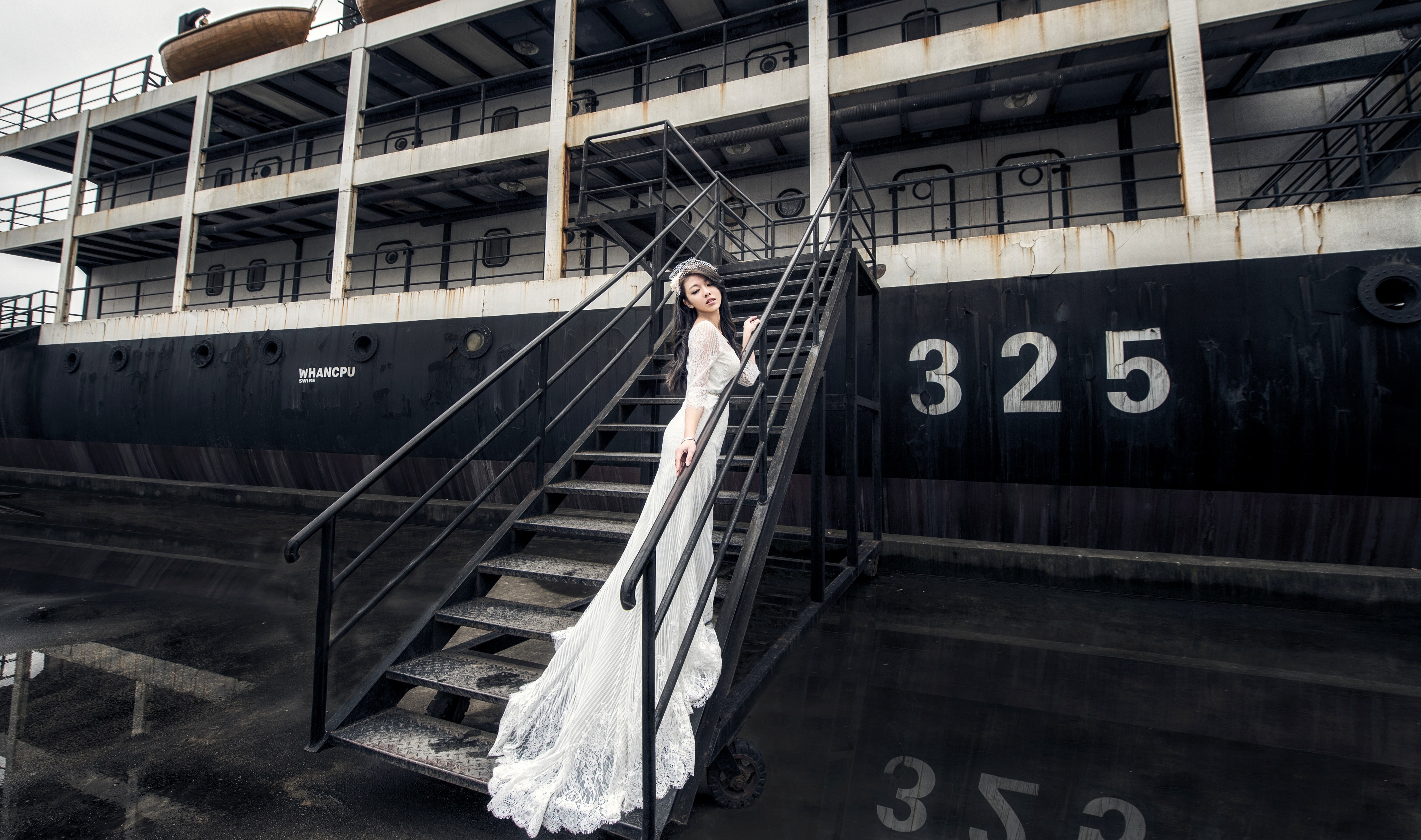 Woman in wedding dress on ship stairs HD Wallpaper