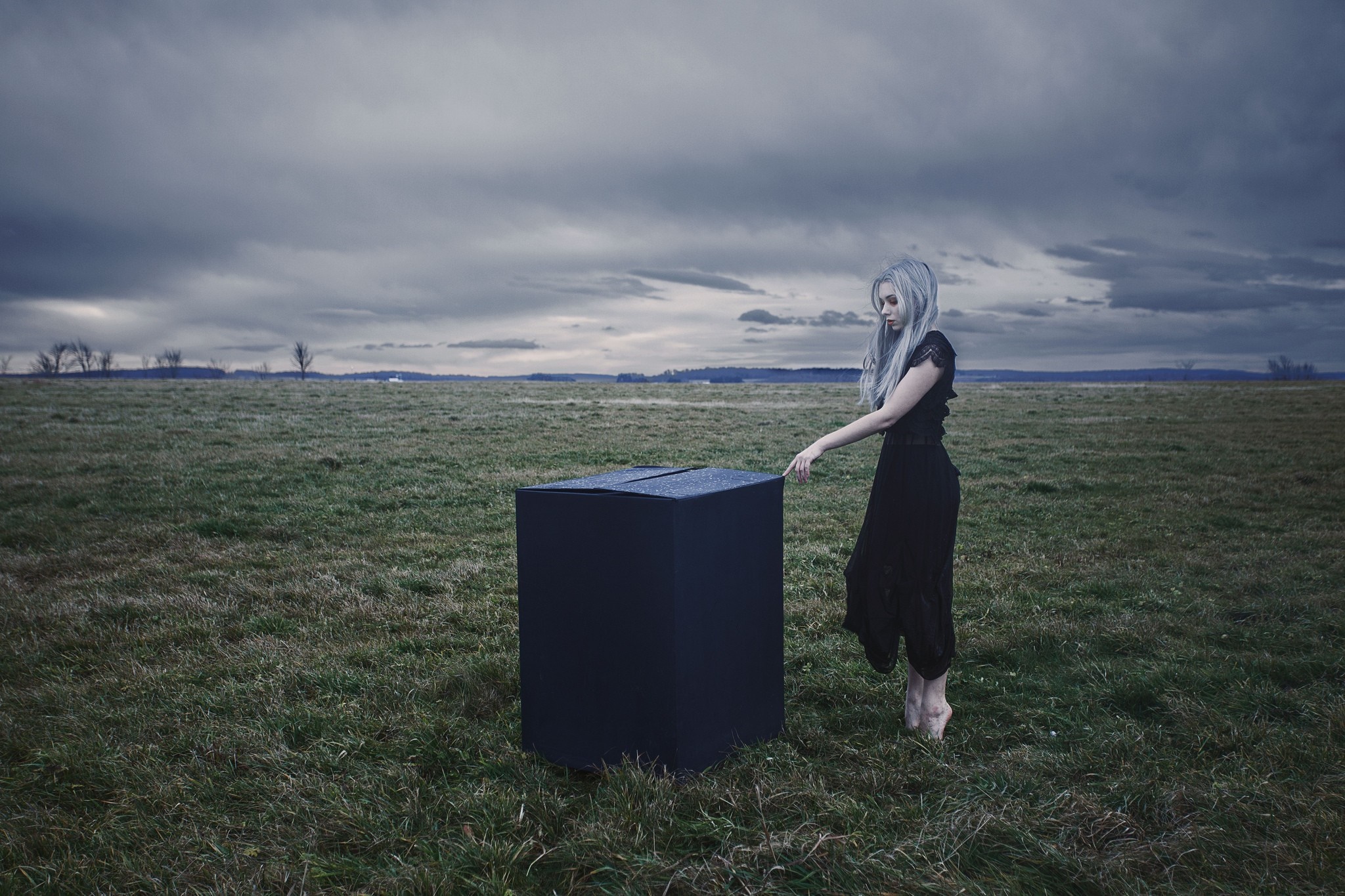 Woman in black dress with black cube in field HD Wallpaper