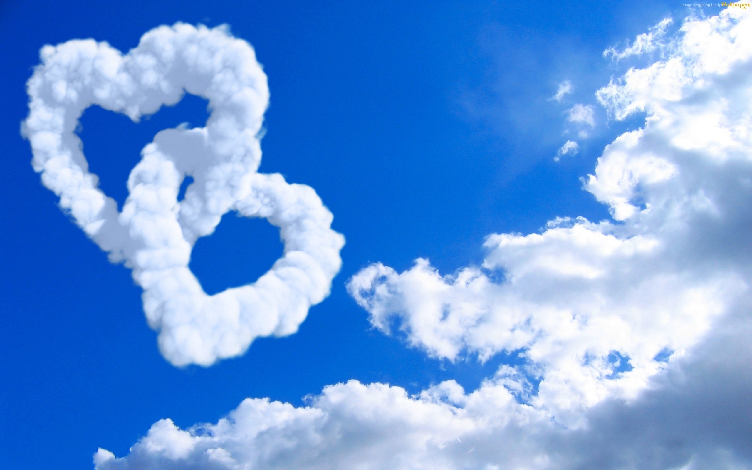 Two Intertwined Heart Clouds in a Blue Sky HD Wallpaper