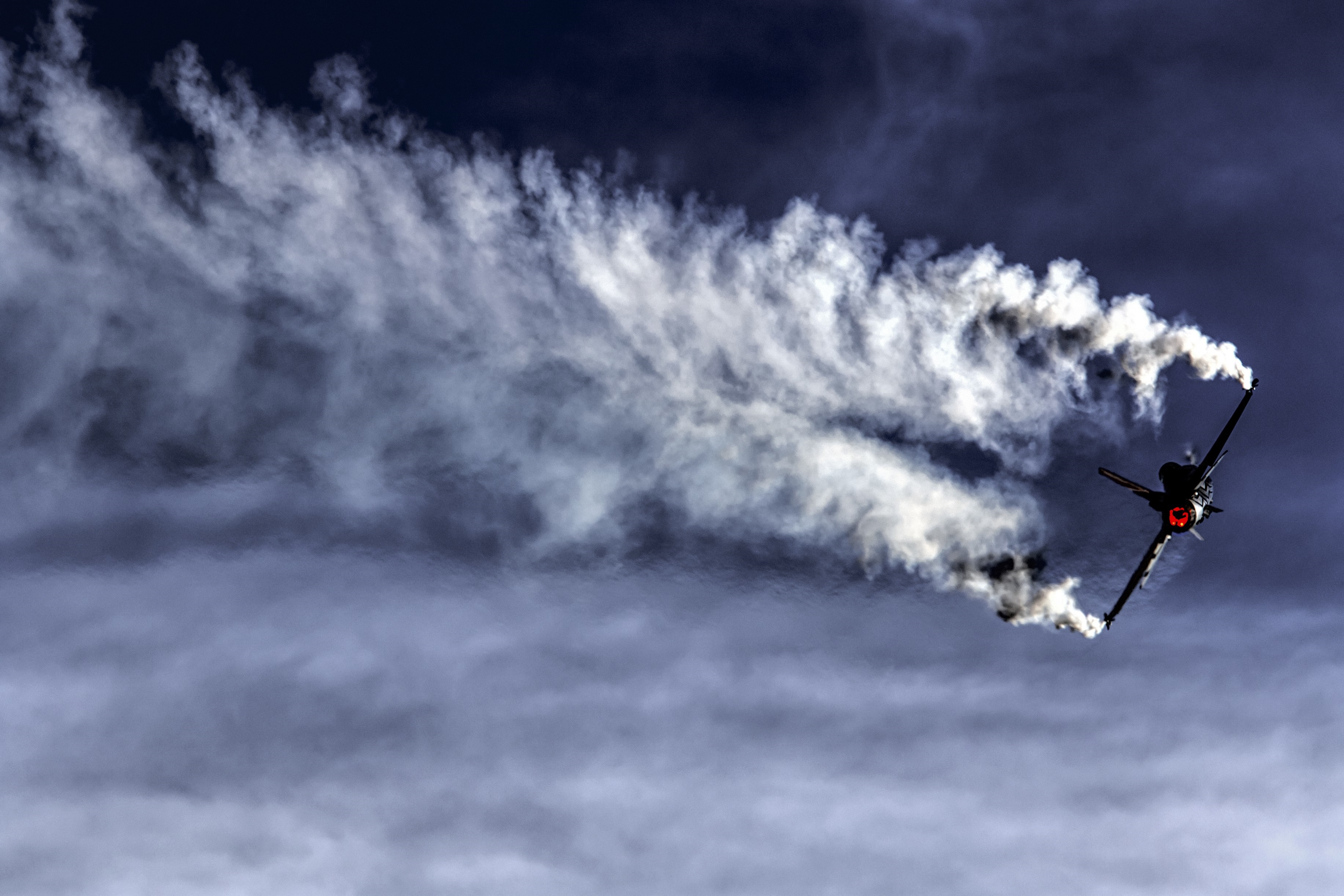 F-16 Fighting Falcon performing aerobatics with smoke trails HD Wallpaper