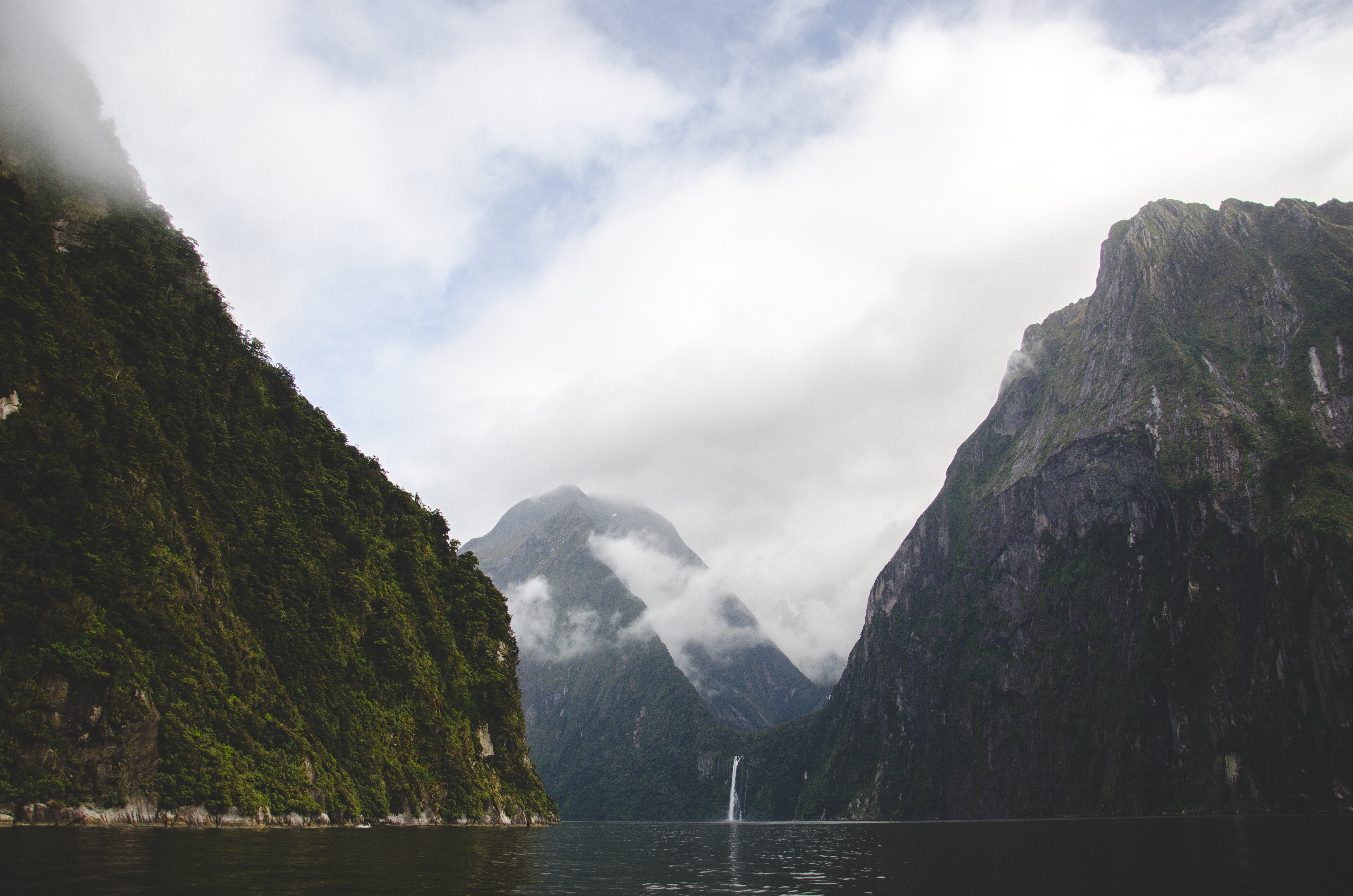 Misty mountains and waterfall in a fjord HD Wallpaper