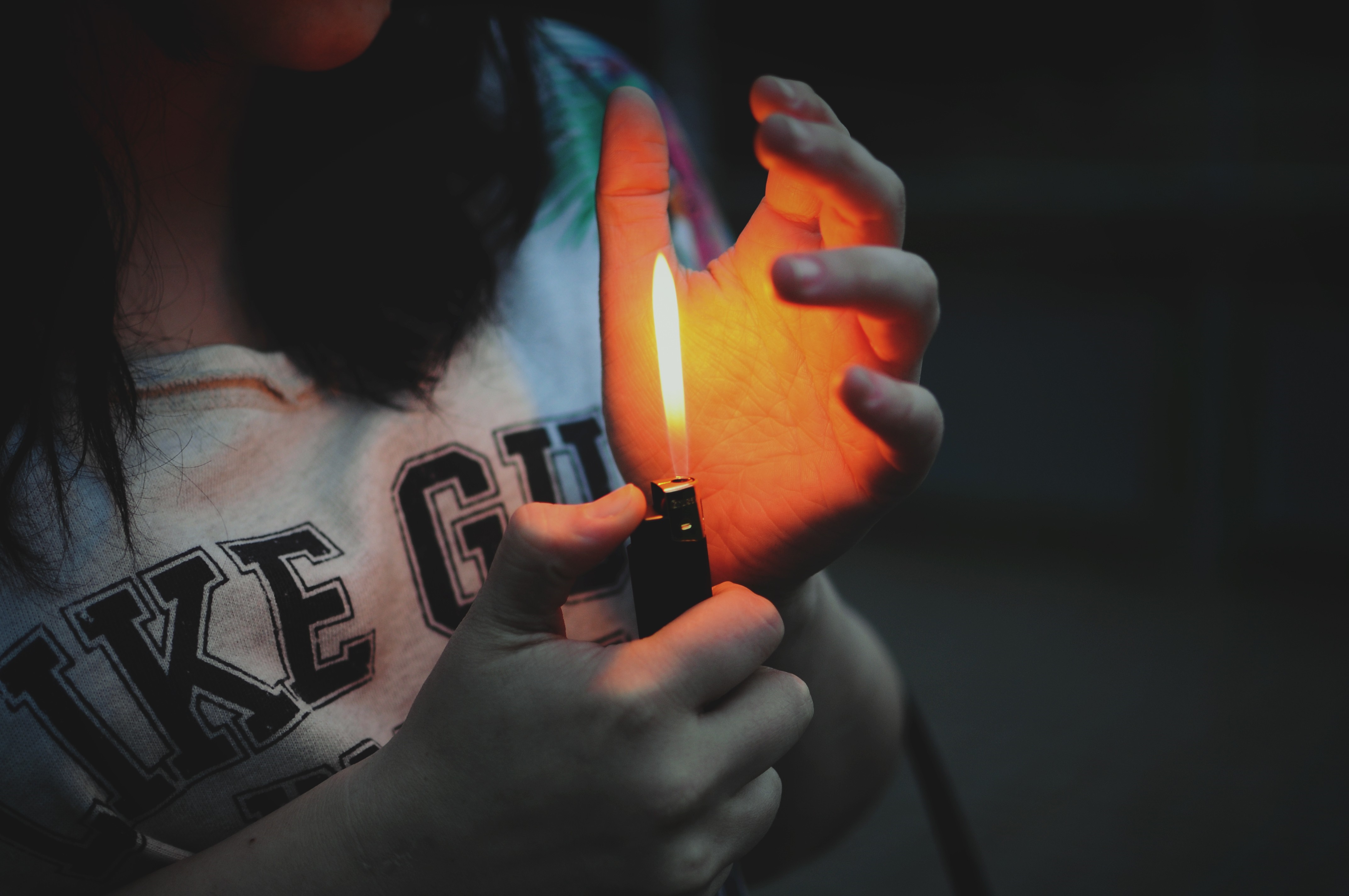 Person holding a lighter with flame on hand HD Wallpaper