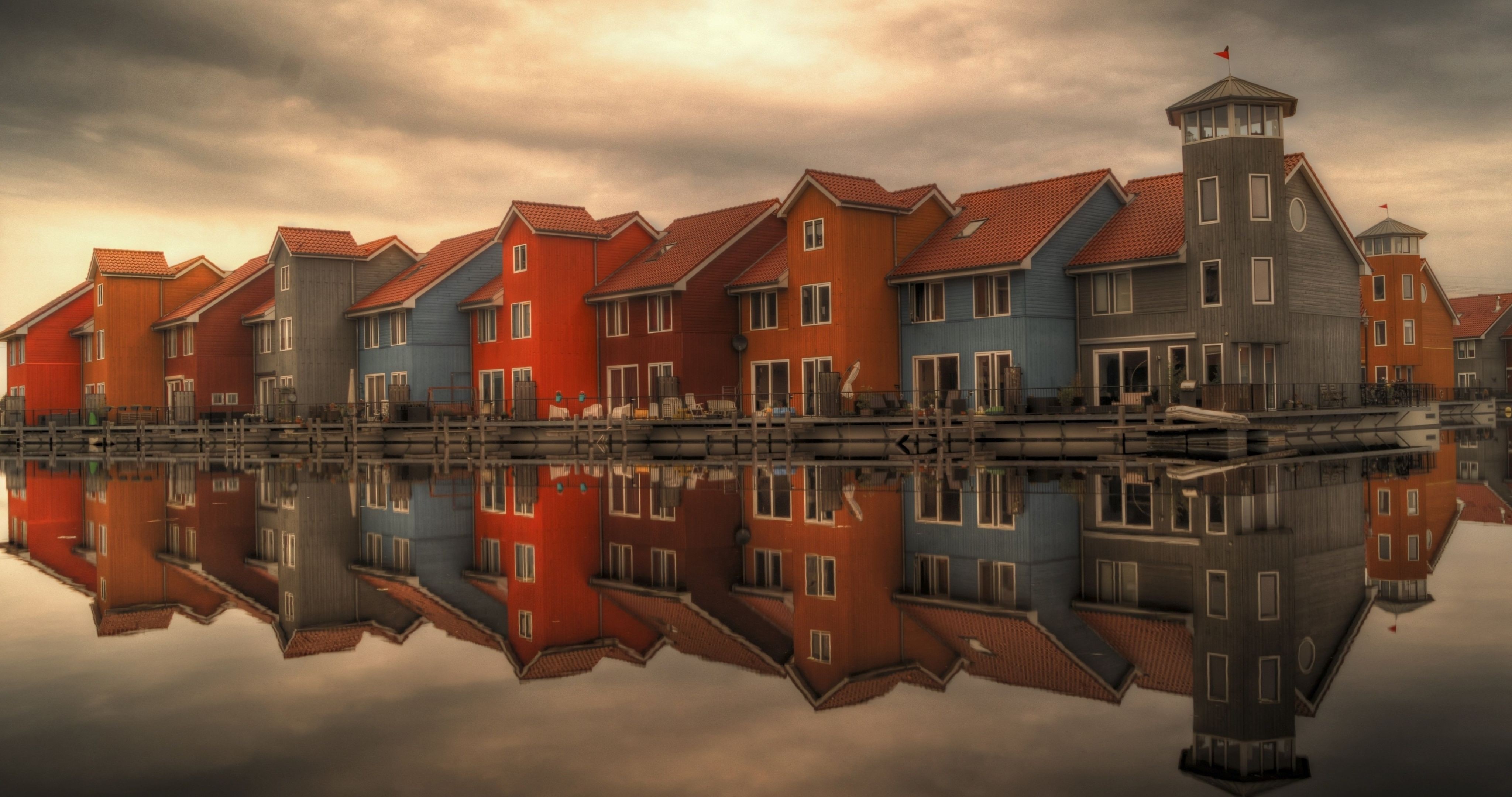 Colorful houses reflected in water at dusk HD Wallpaper