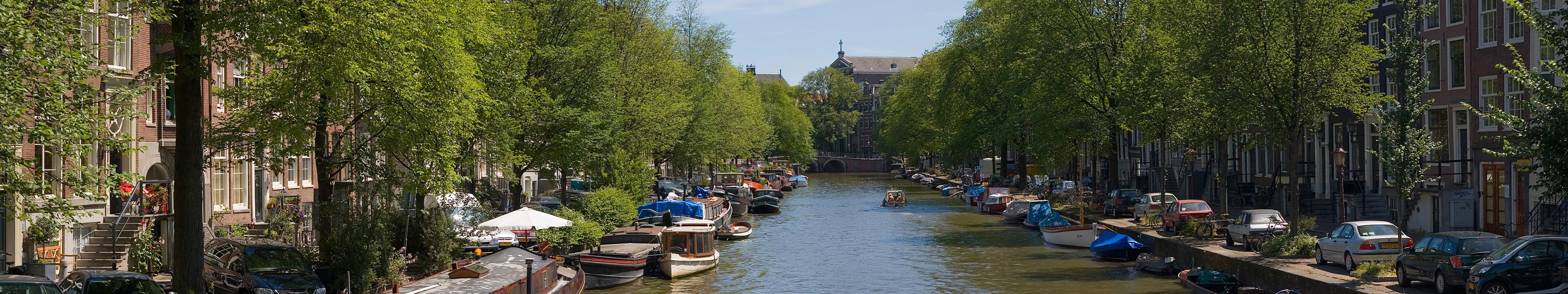 Amsterdam canal with boats and trees HD Wallpaper