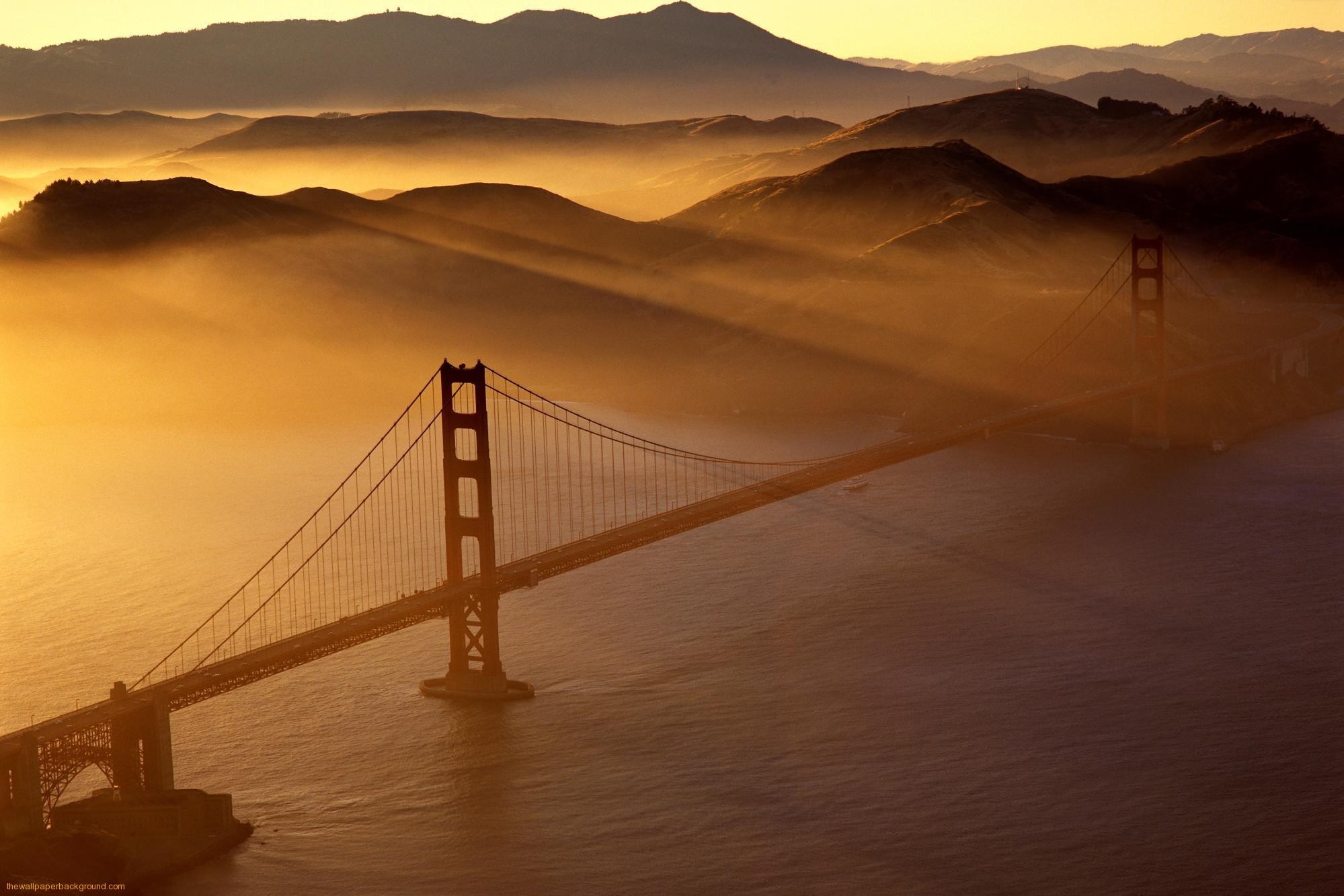 Golden Gate Bridge at sunrise with fog and mountains HD Wallpaper