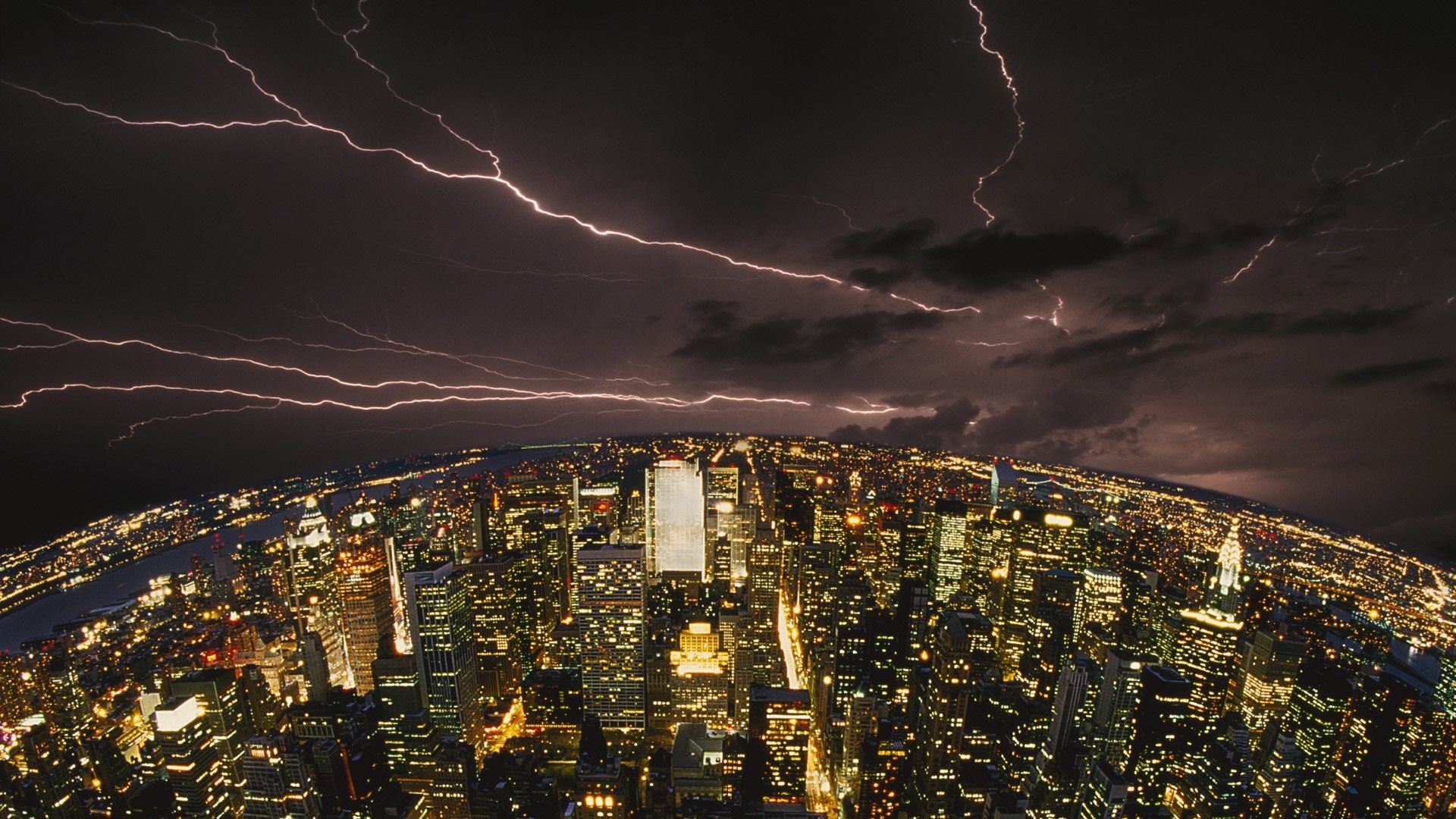 Cityscape at night with lightning storm over buildings HD Wallpaper