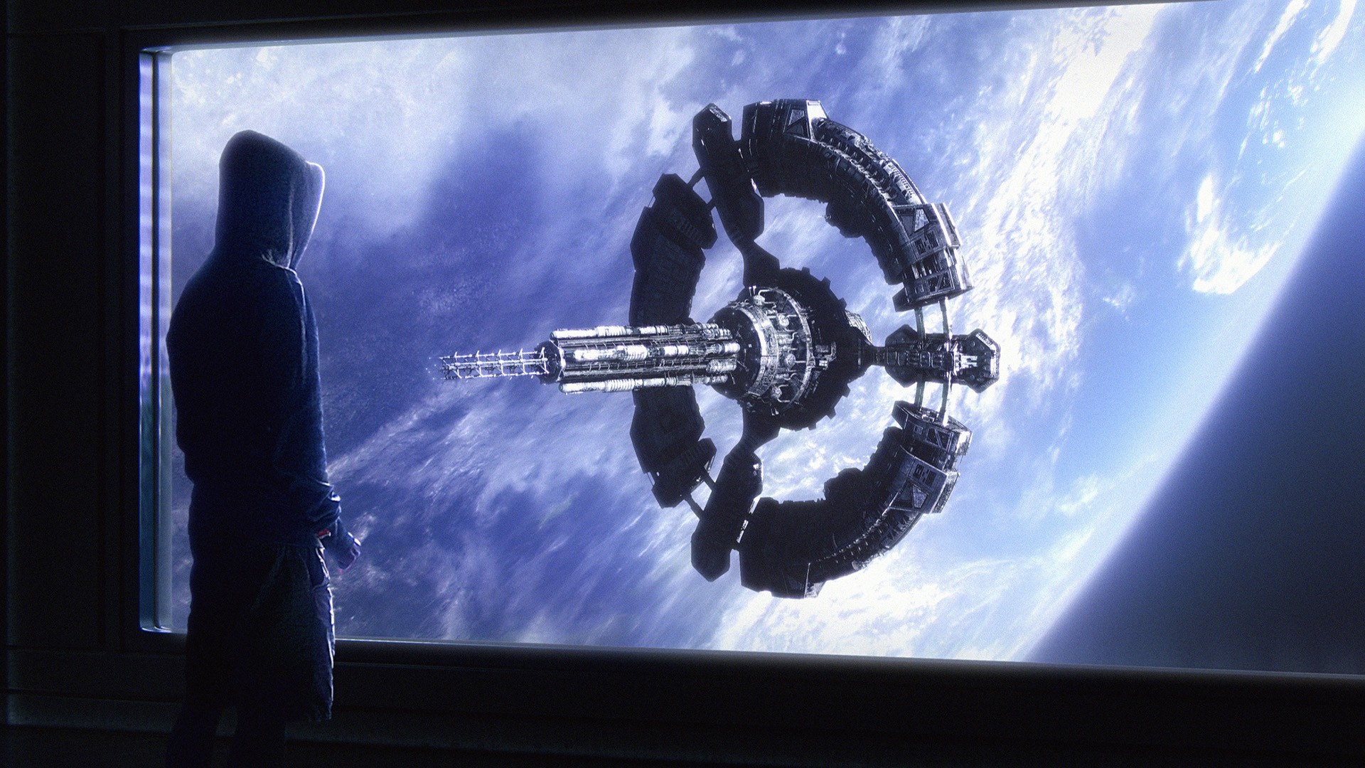 Person in hoodie looking at space station orbiting Earth HD Wallpaper