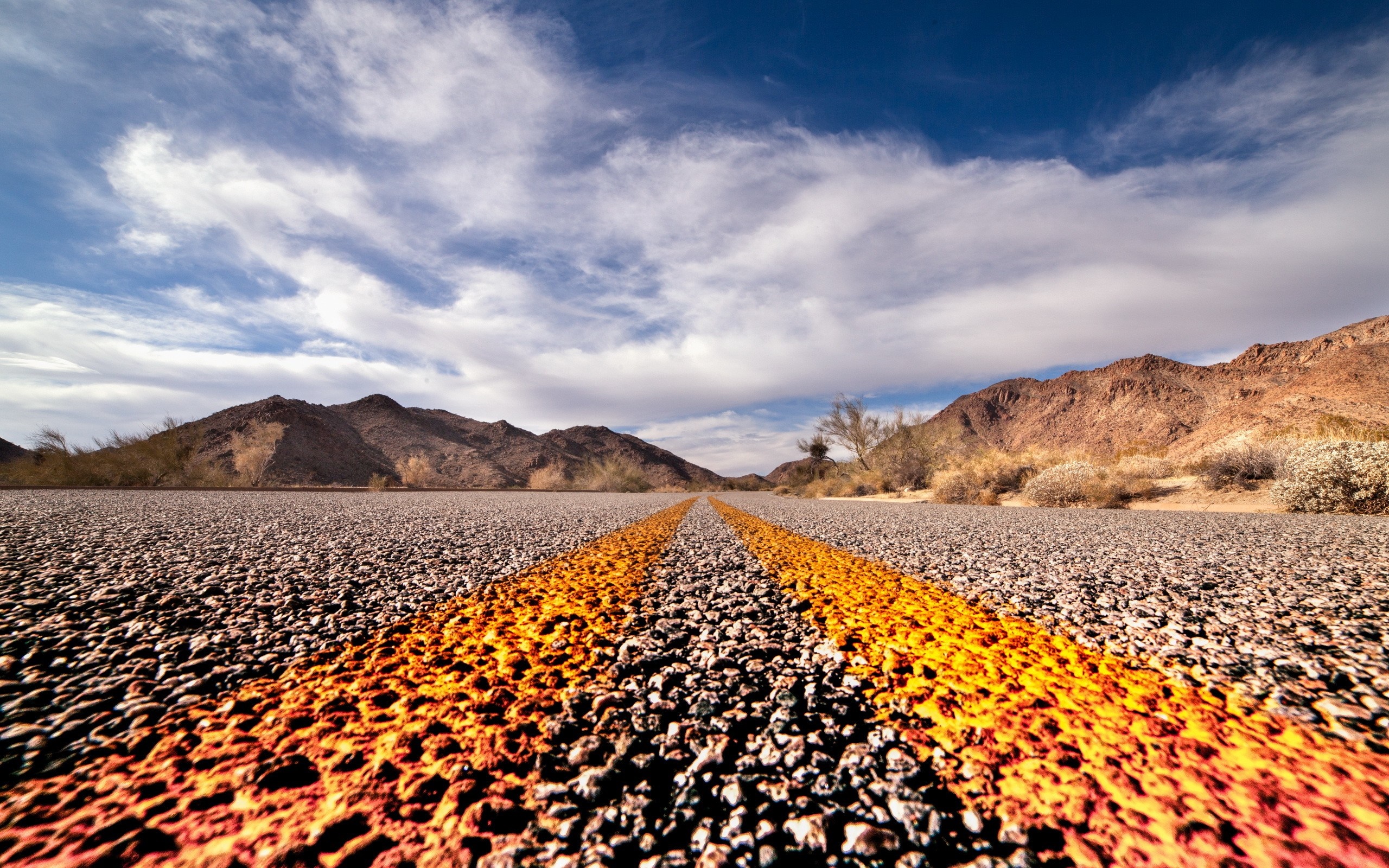 Desert road with mountains and clouds HD Wallpaper