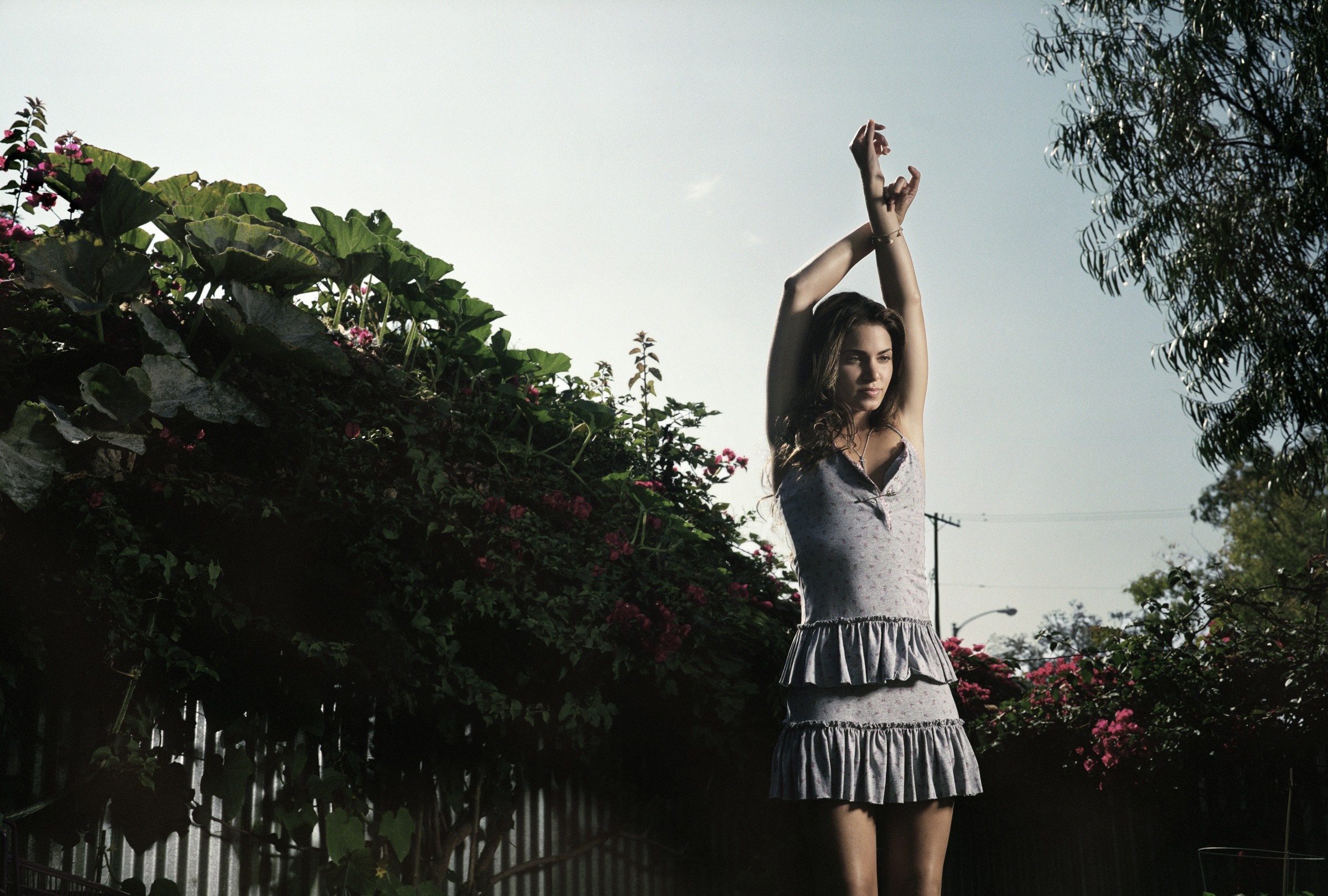 Woman in a dress with arms raised outdoors HD Wallpaper