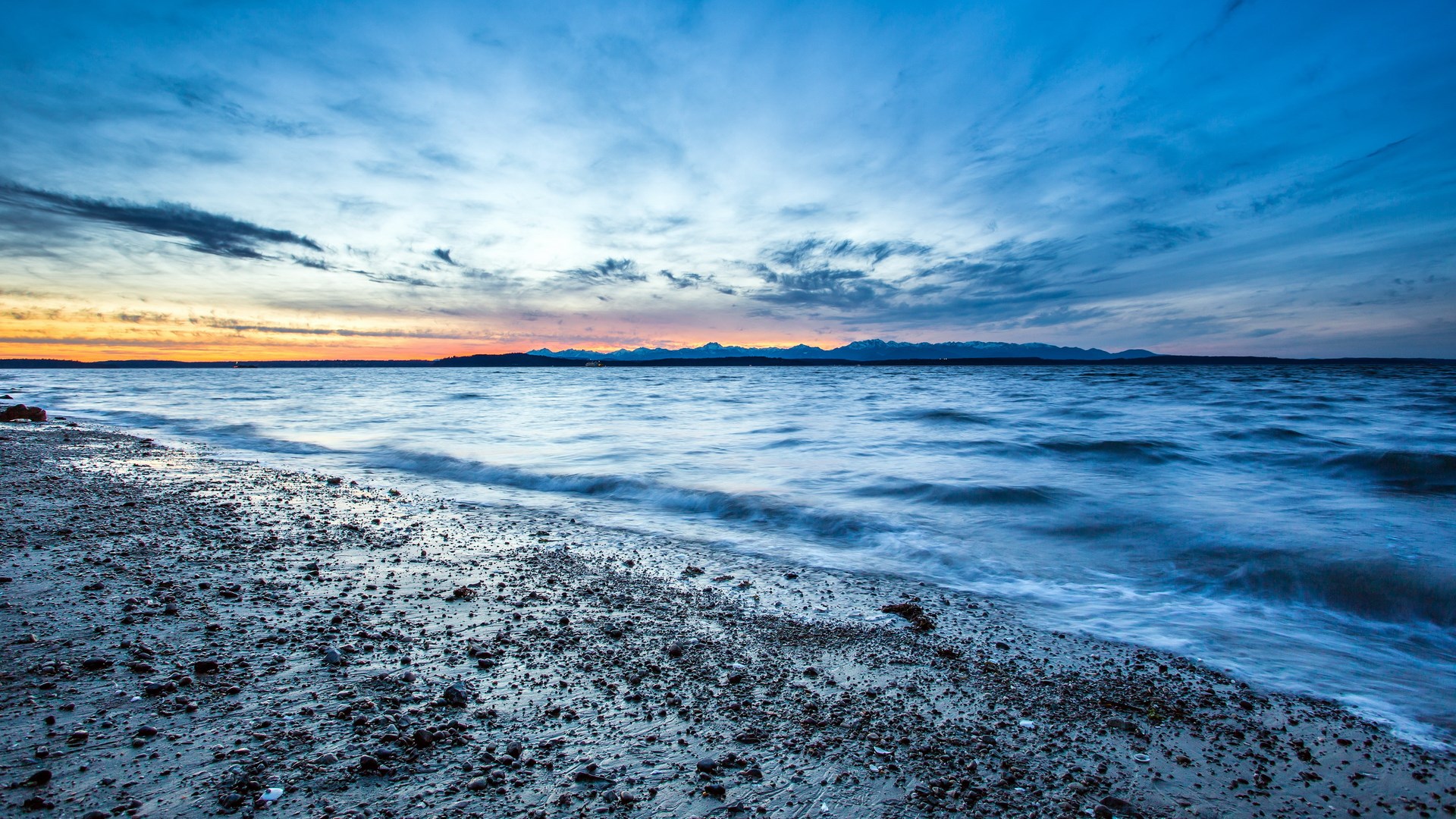 Ocean waves on a rocky beach at sunset HD Wallpaper