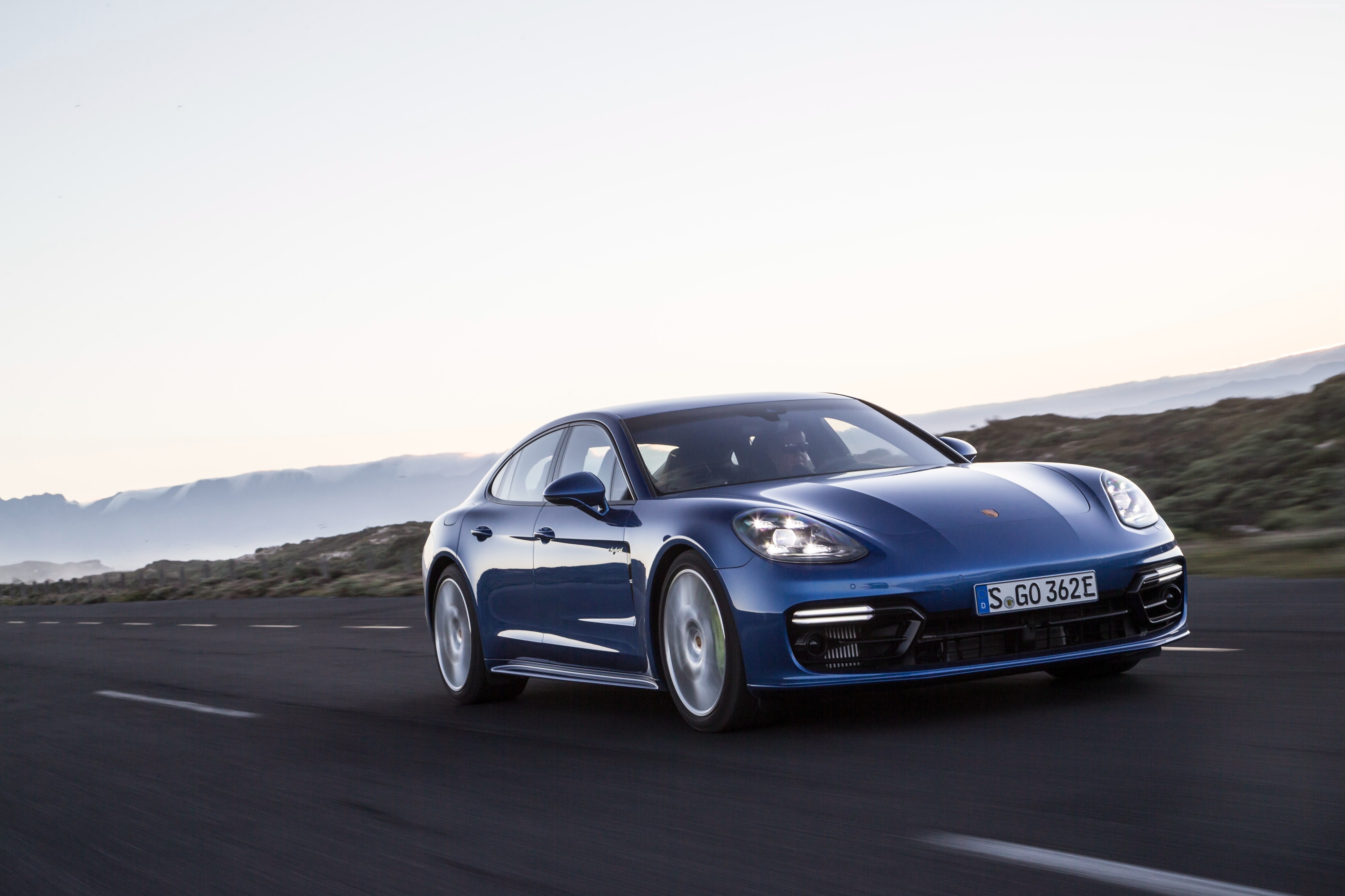 Porsche Panamera 4 E-Hybrid driving on a road HD Wallpaper