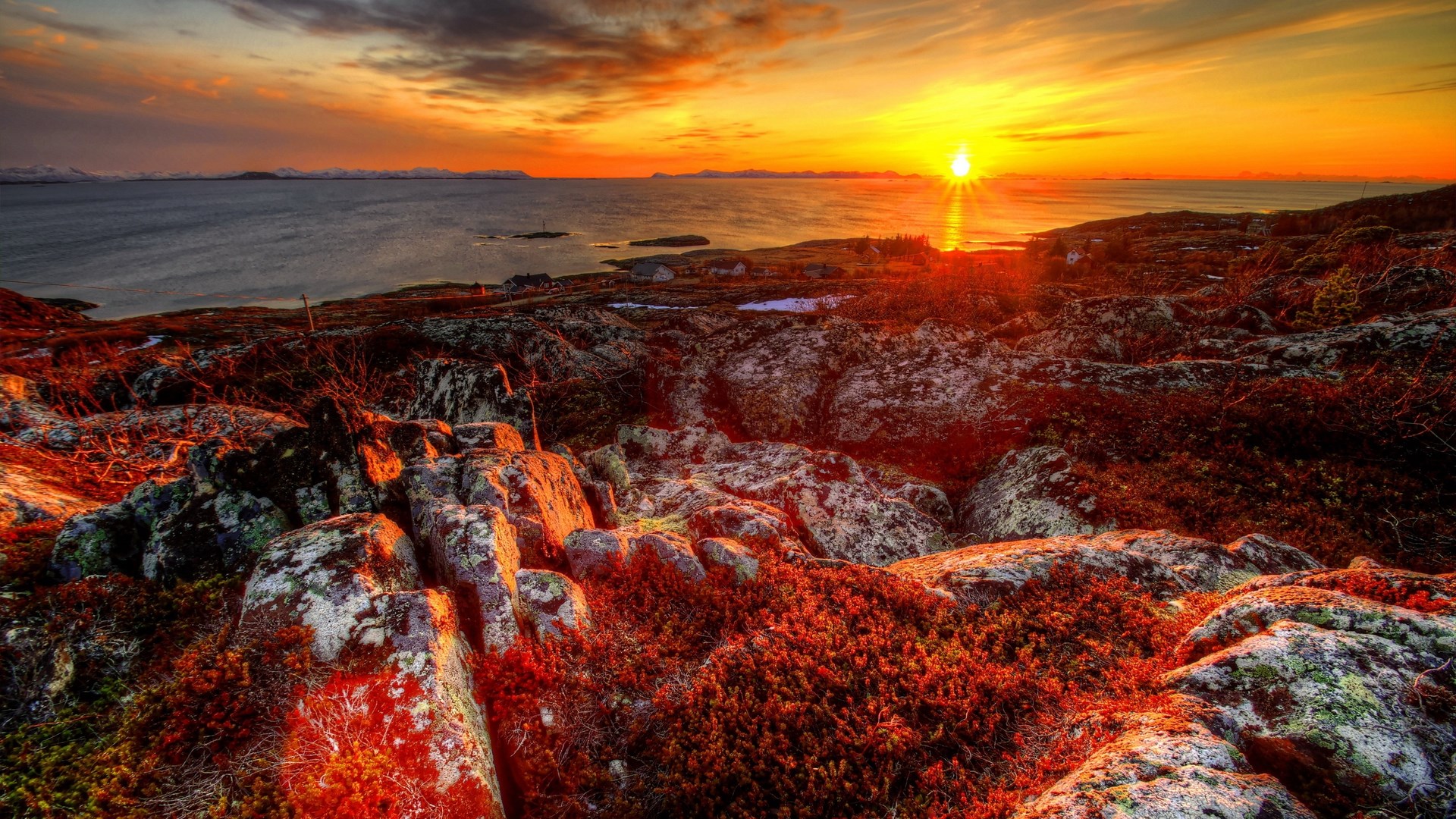 Sunset over rocky coast with ocean and mountains HD Wallpaper