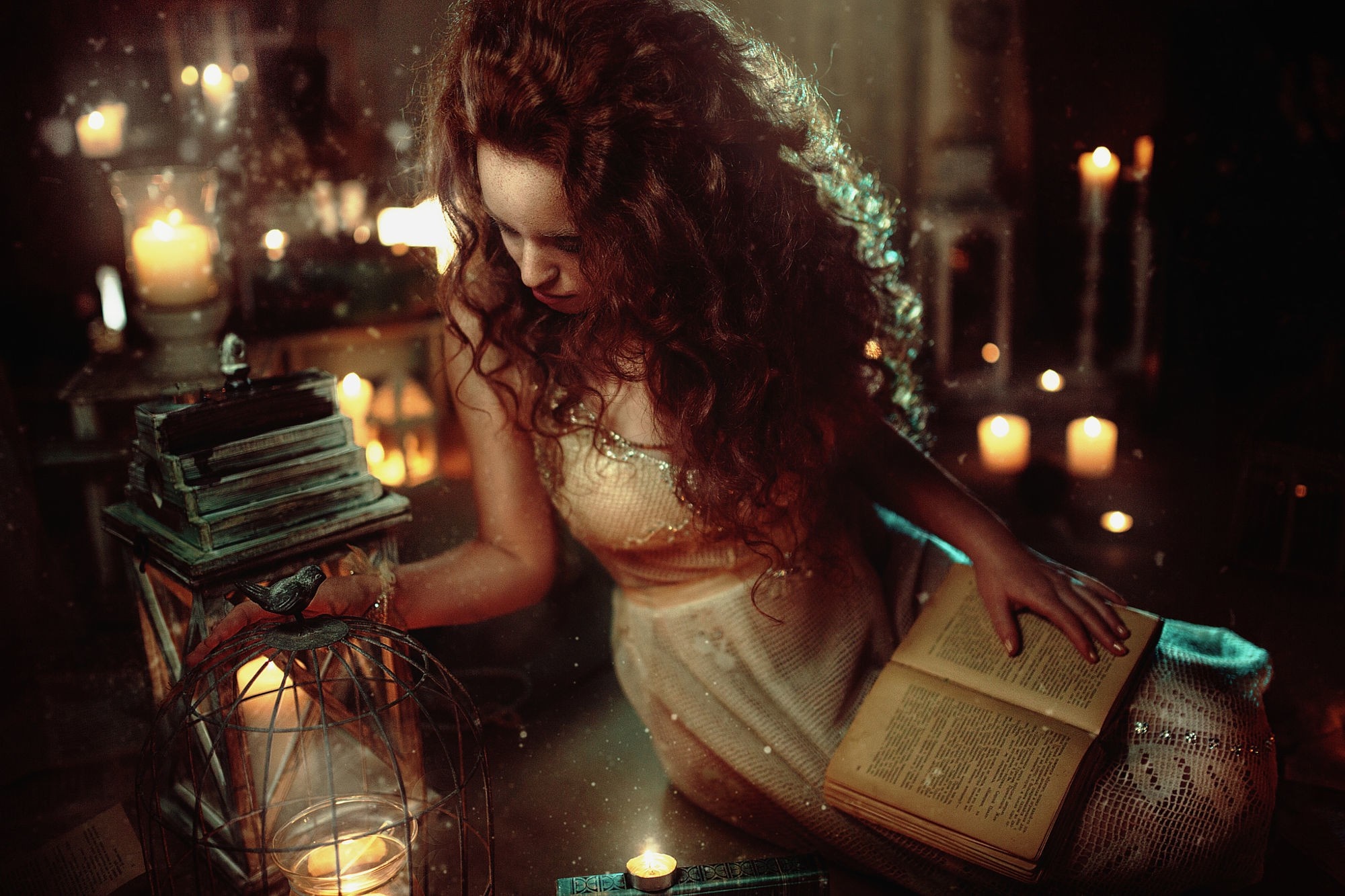 Woman with curly hair reading by candlelight HD Wallpaper