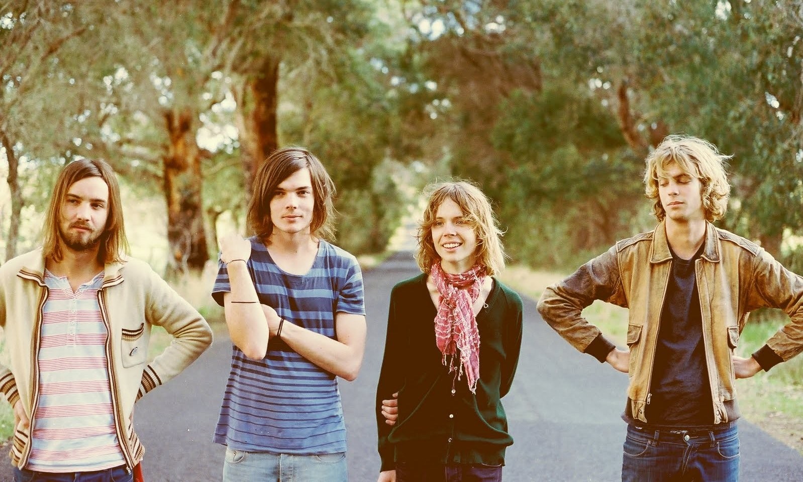 Four men standing on a road HD Wallpaper