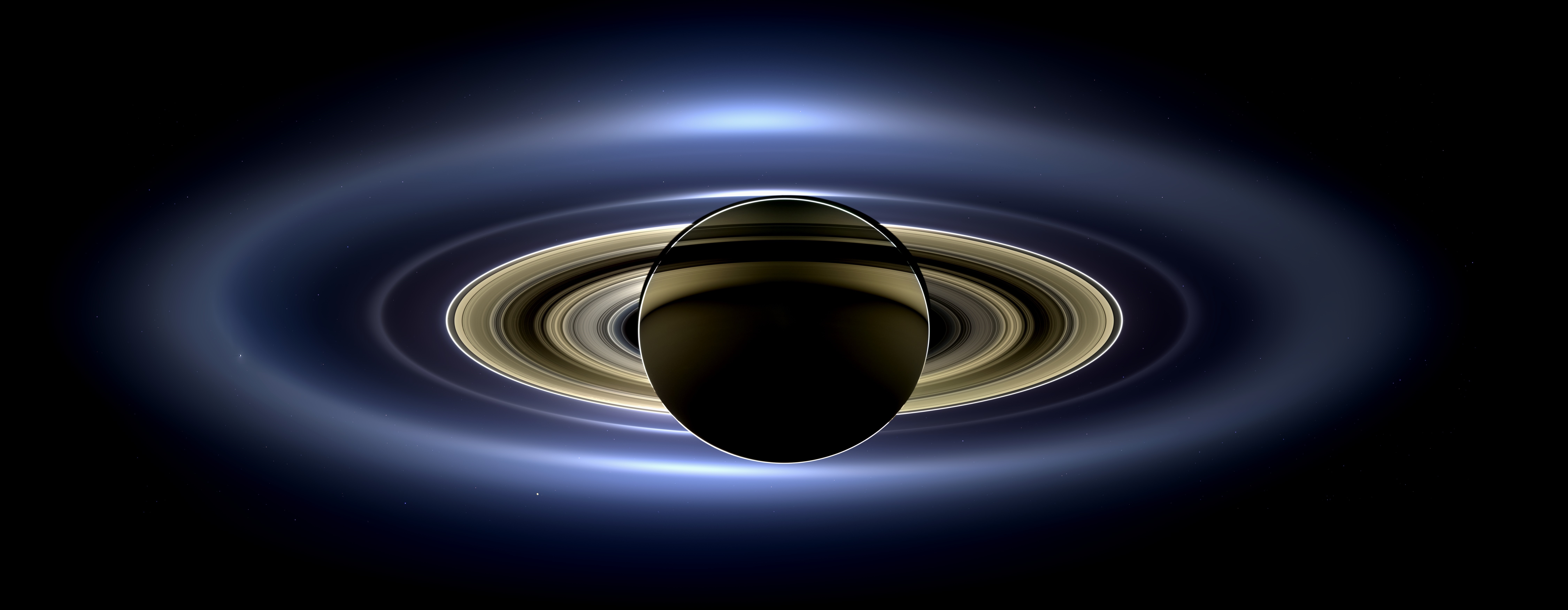 Saturn and its rings with a blue glow HD Wallpaper