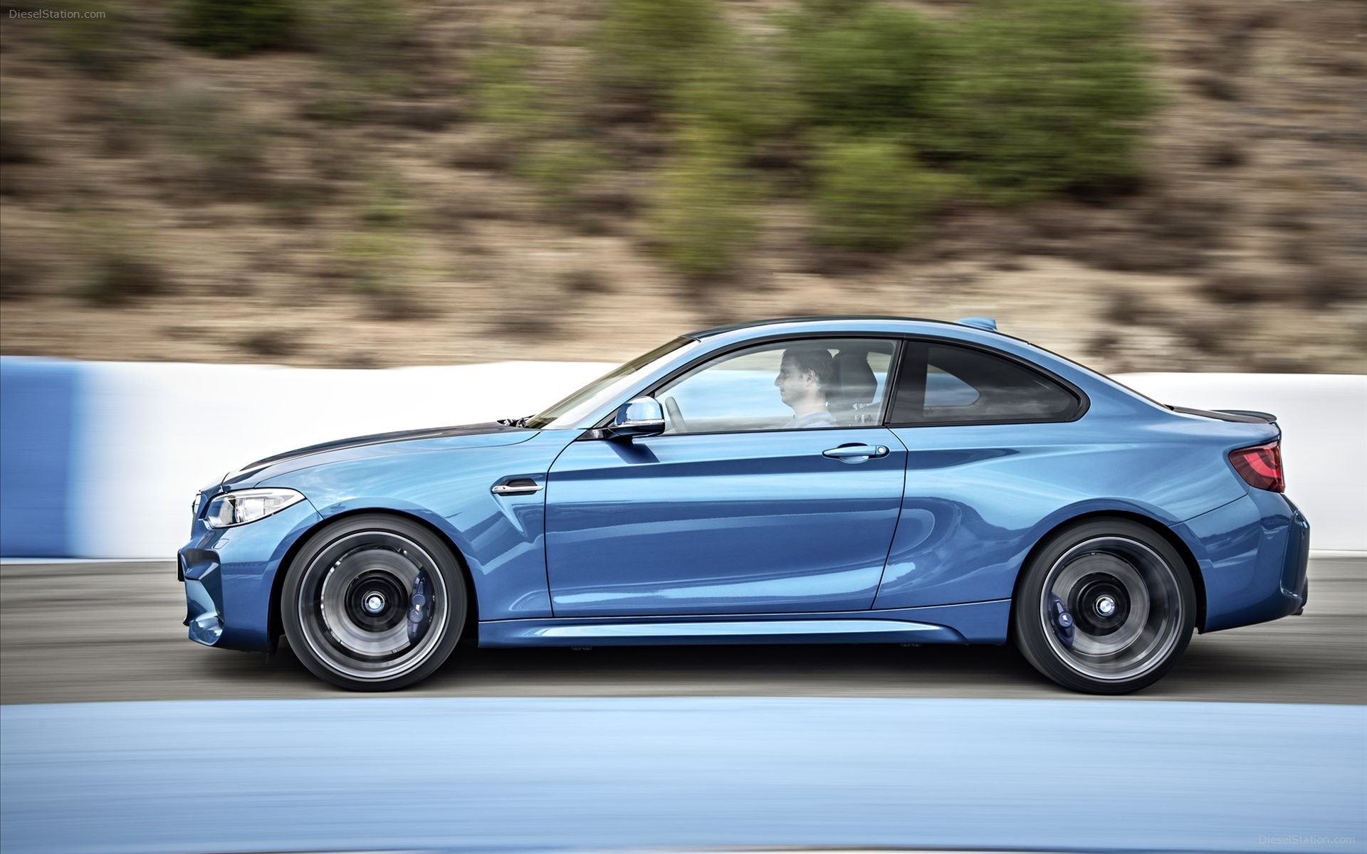 Blue BMW M2 driving on a track HD Wallpaper