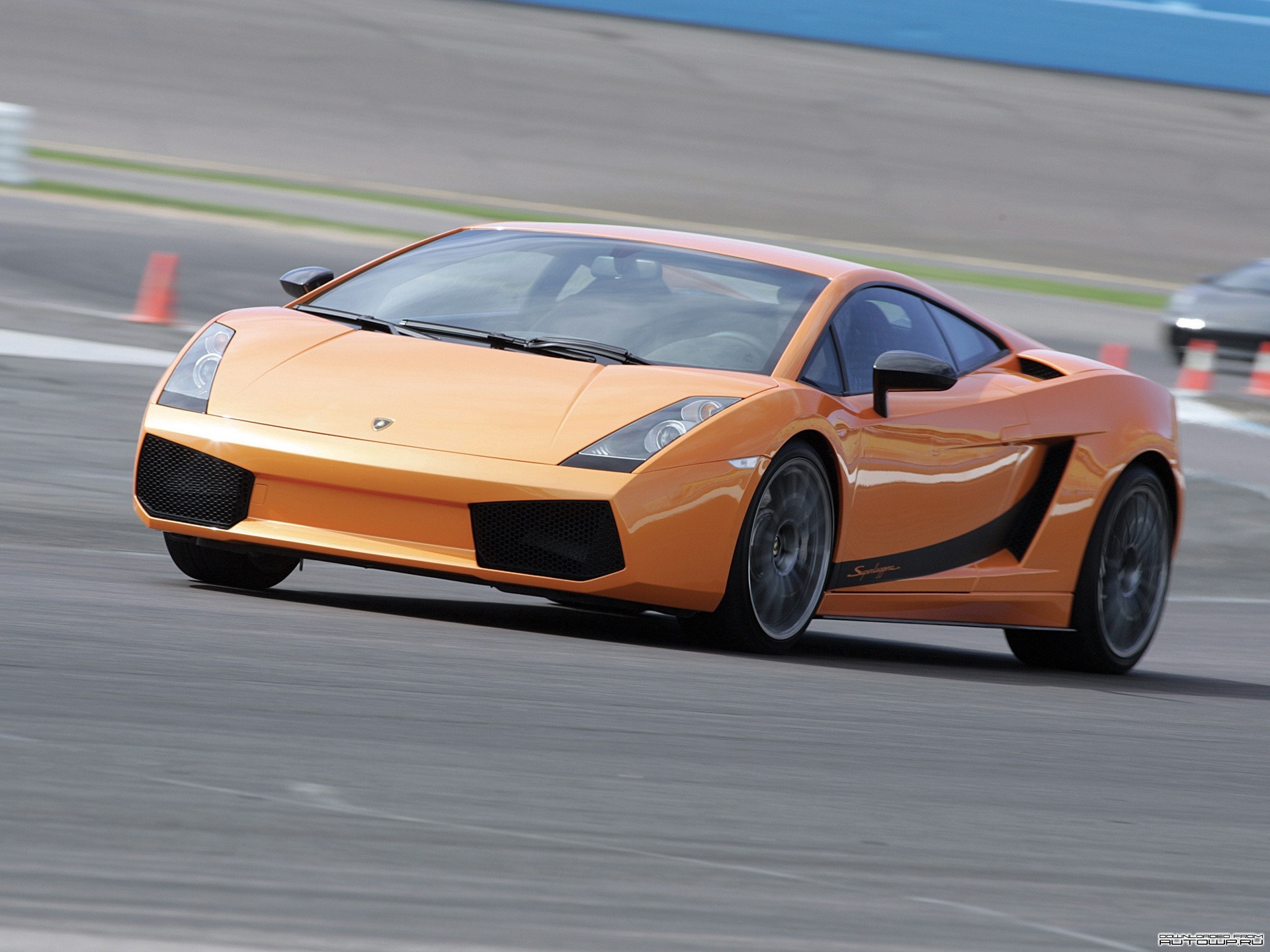 Orange Lamborghini Gallardo driving on a race track HD Wallpaper