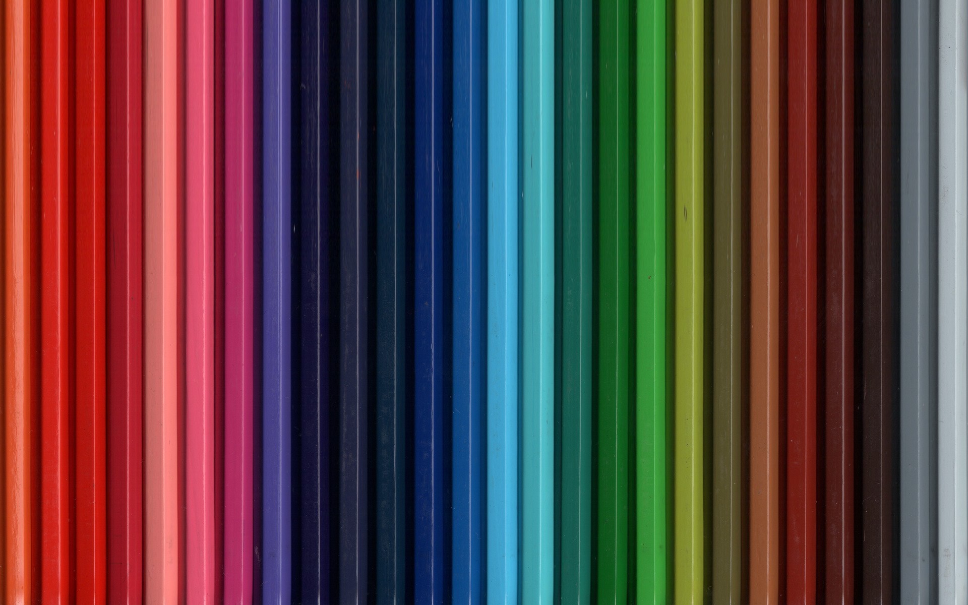 A spectrum of colored pencils arranged vertically HD Wallpaper