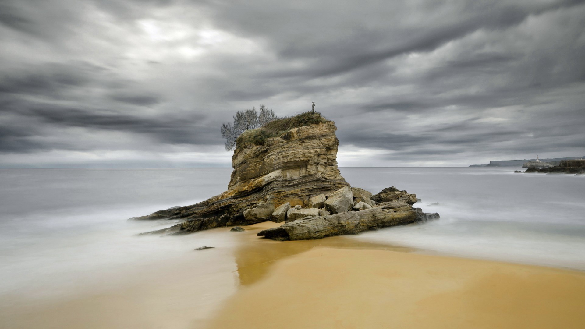 Rock formation in the sea under cloudy sky HD Wallpaper