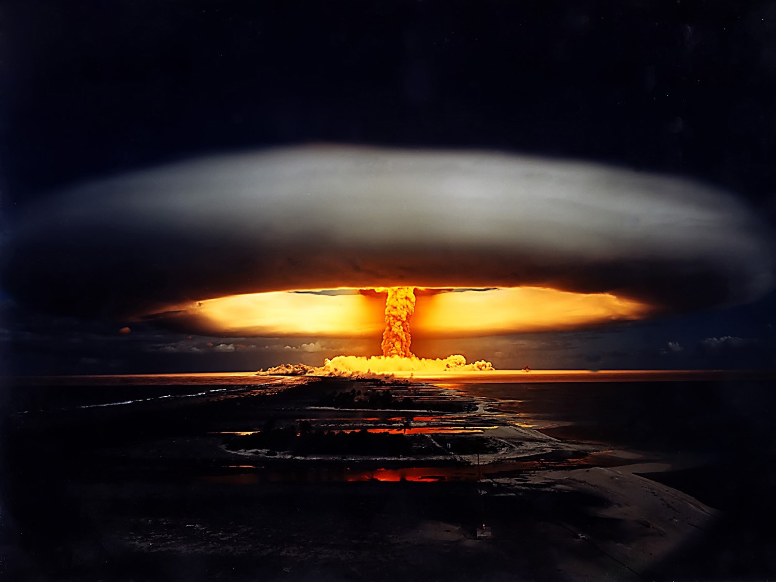 Nuclear explosion mushroom cloud over water at night HD Wallpaper