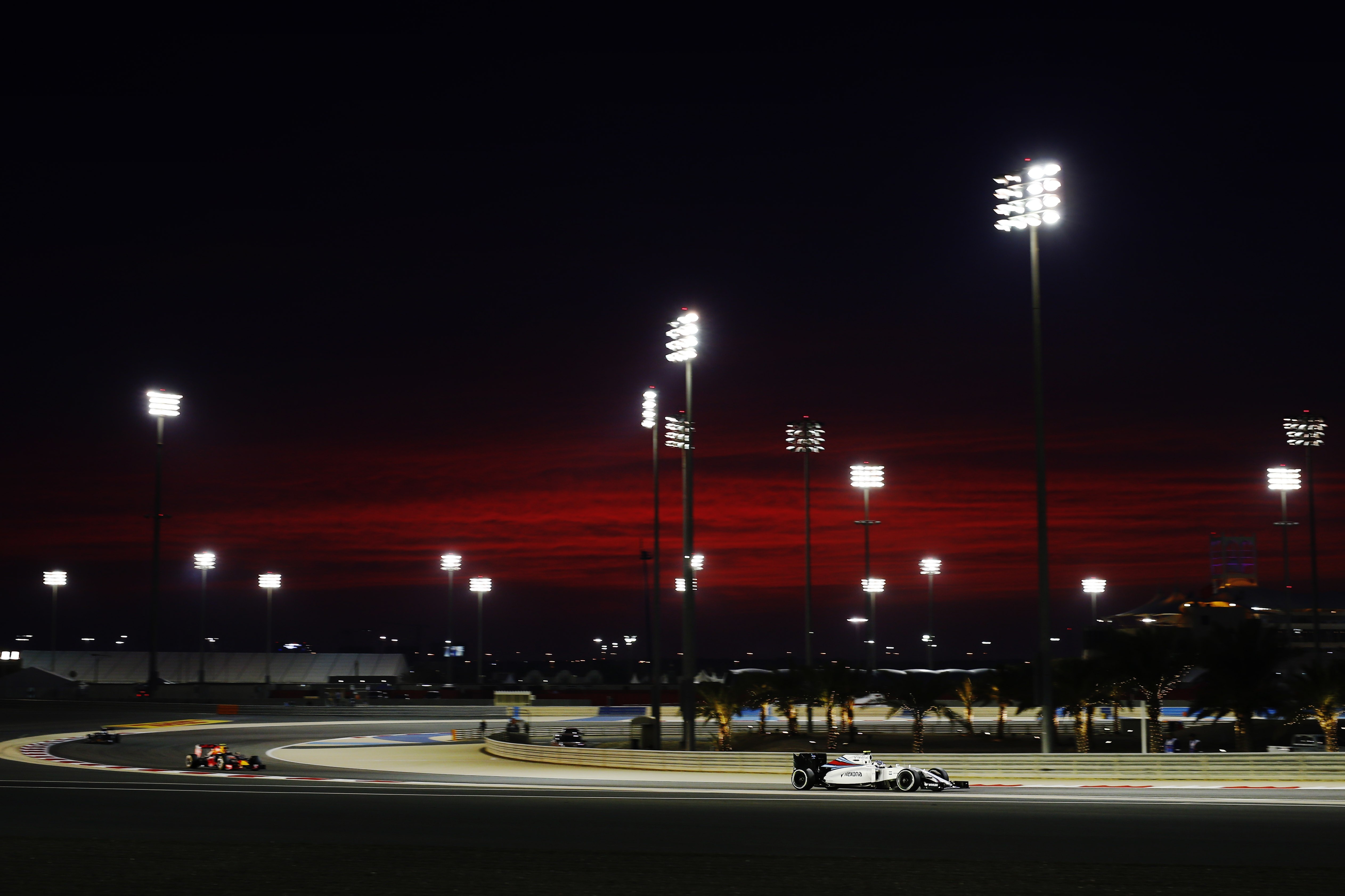 Formula 1 race at night with stadium lights HD Wallpaper