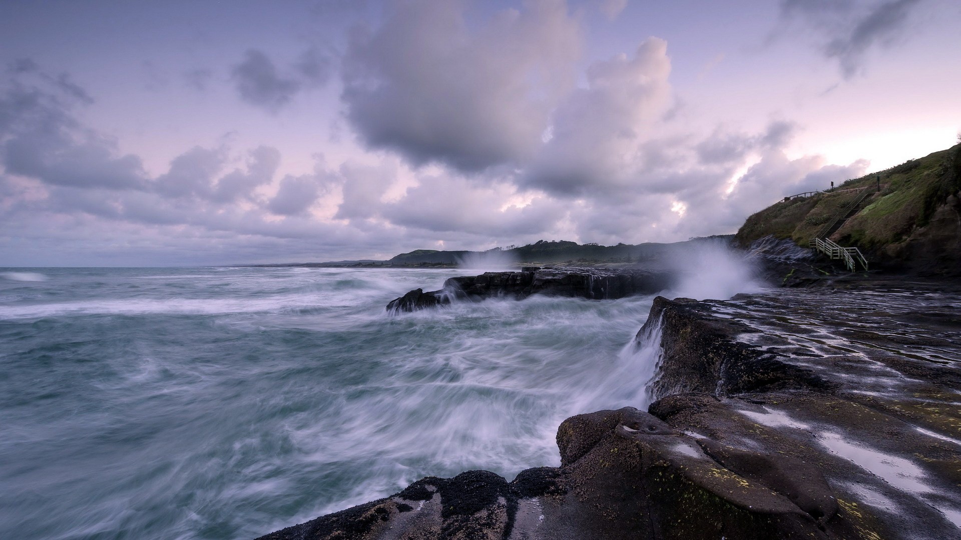 Waves crashing on rocky shore with cloudy sky HD Wallpaper