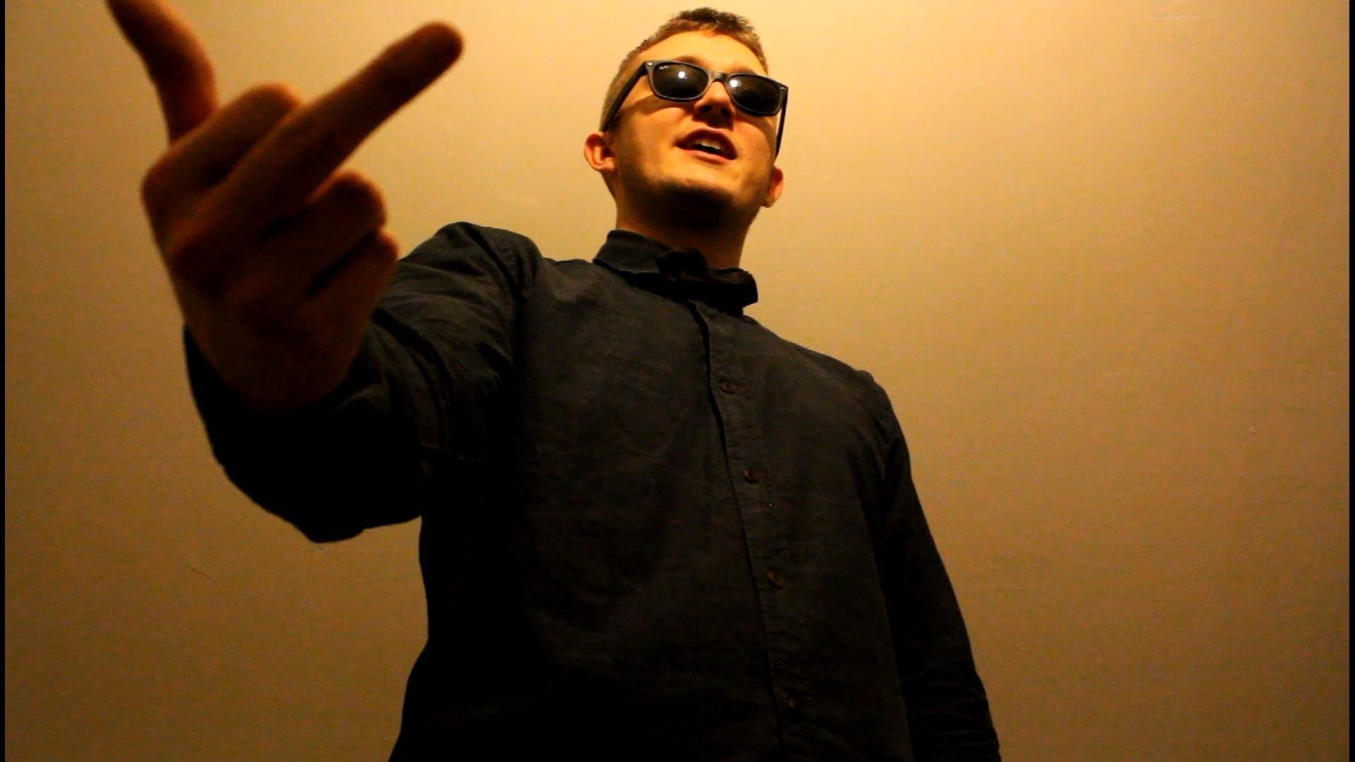 Man in black shirt and sunglasses making a gesture HD Wallpaper