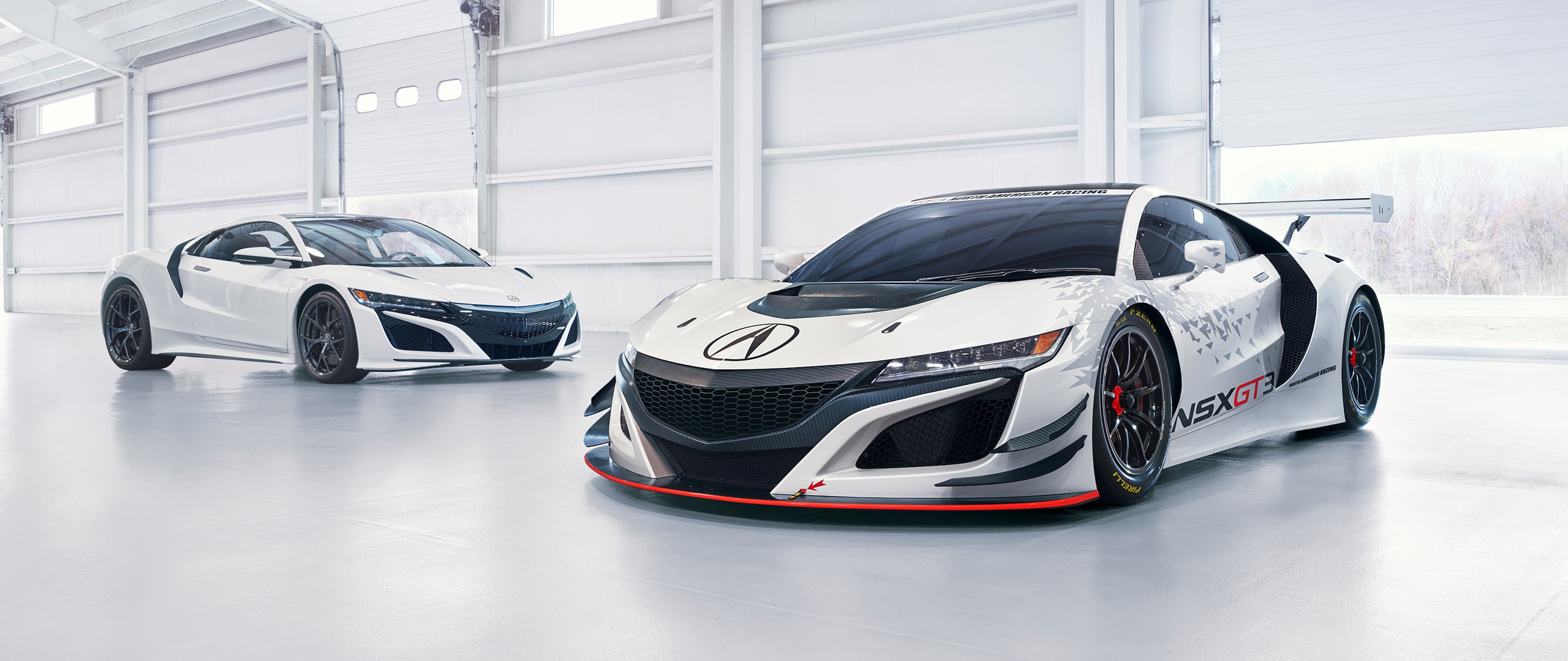Two white Acura NSX GT3 race cars in a garage HD Wallpaper
