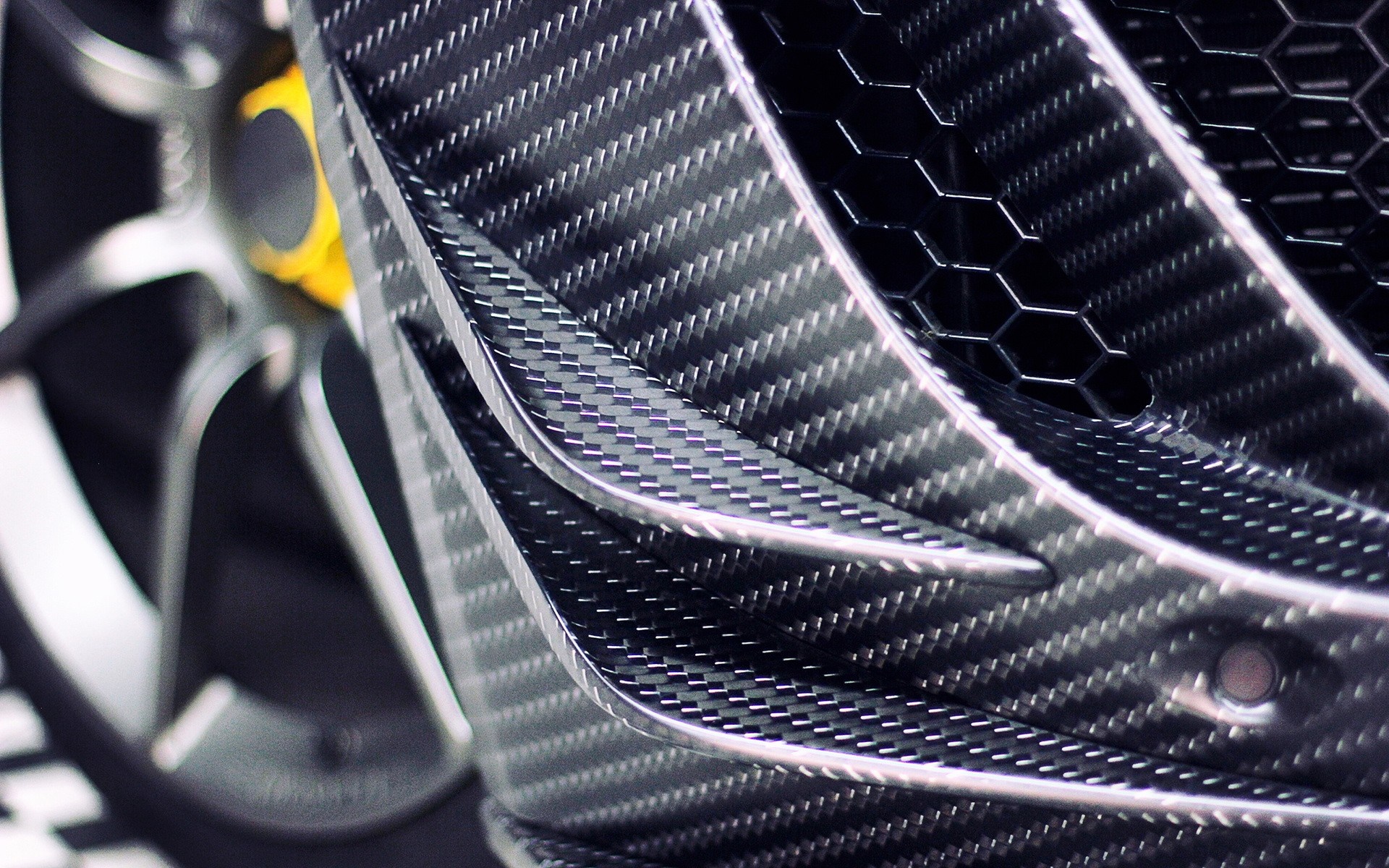 Carbon fiber car body with wheel and yellow brake caliper HD Wallpaper