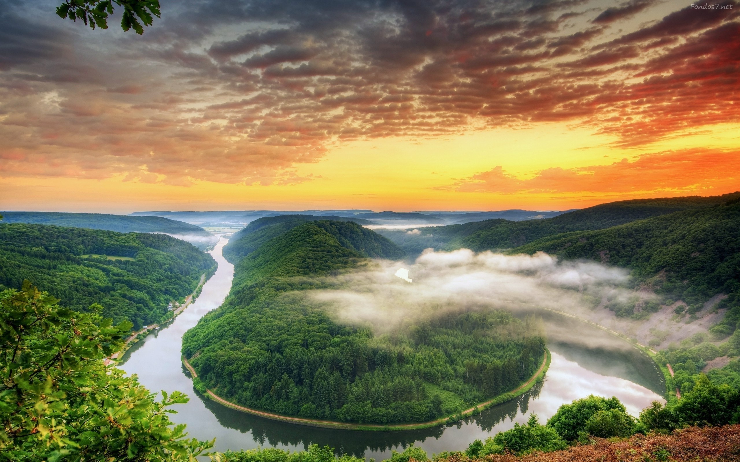 River bend at sunset with clouds over forested hills HD Wallpaper