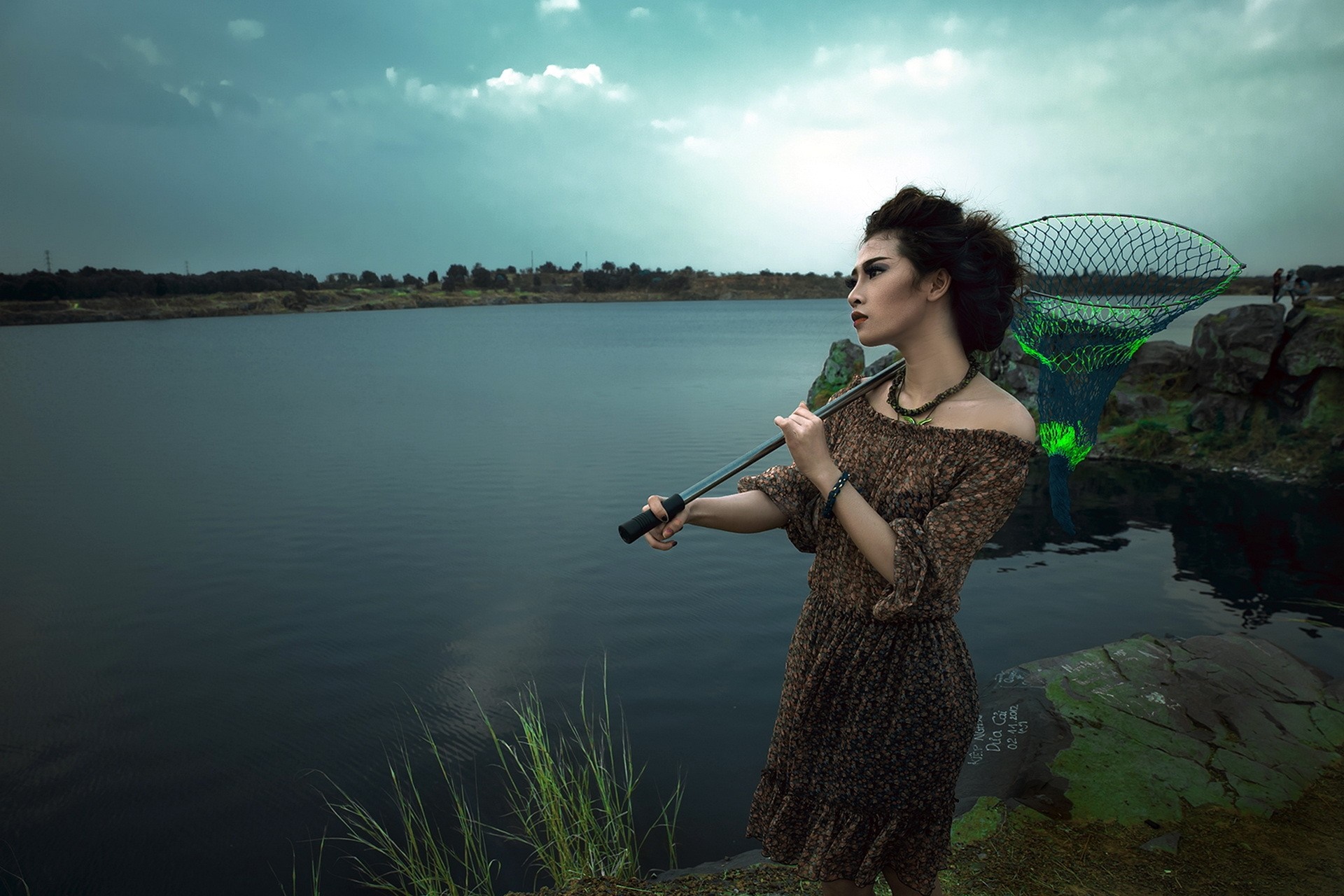 Woman with fishing net by a lake HD Wallpaper