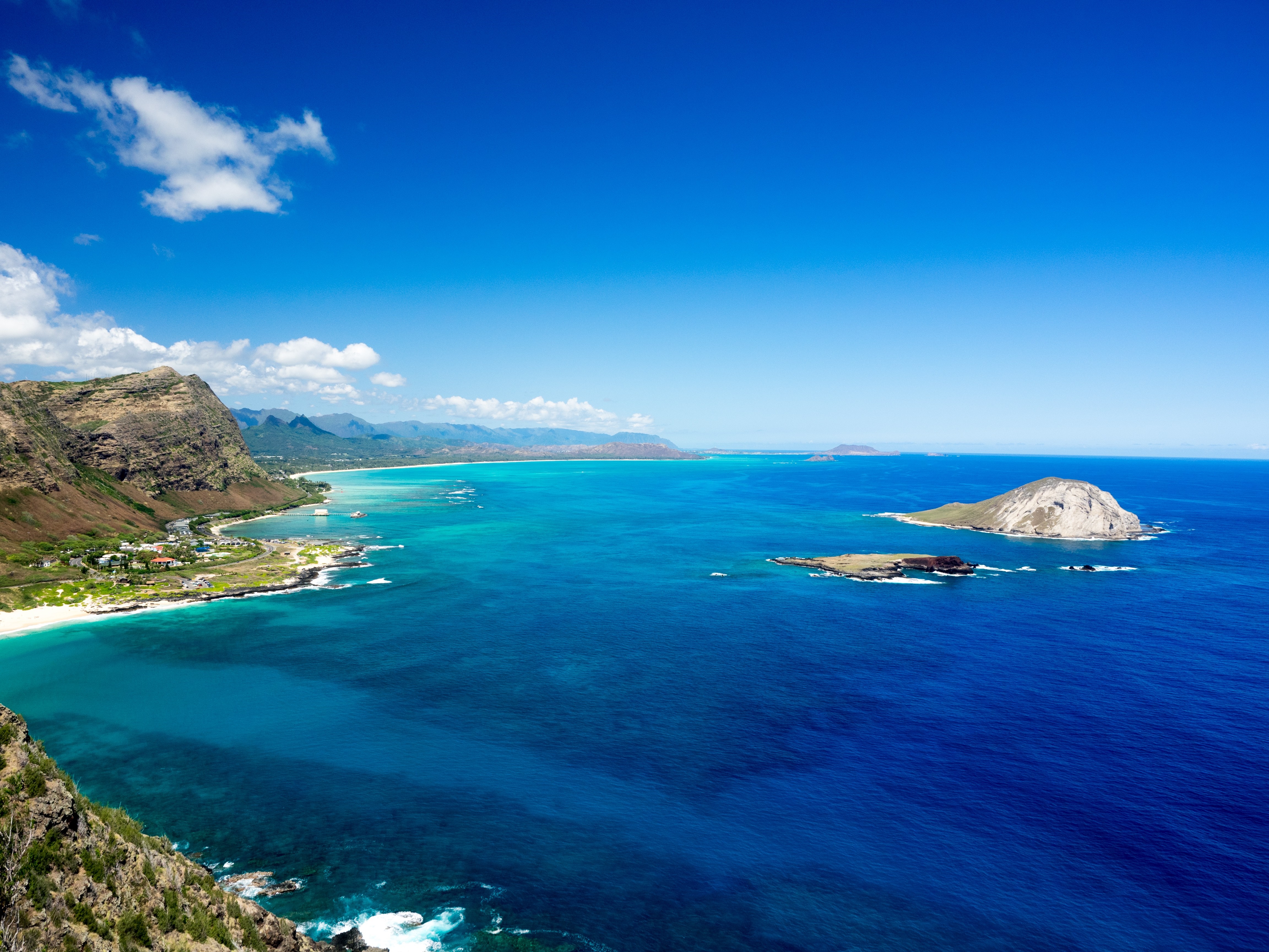 Aerial view of Oahu coastline with islands in the ocean HD Wallpaper