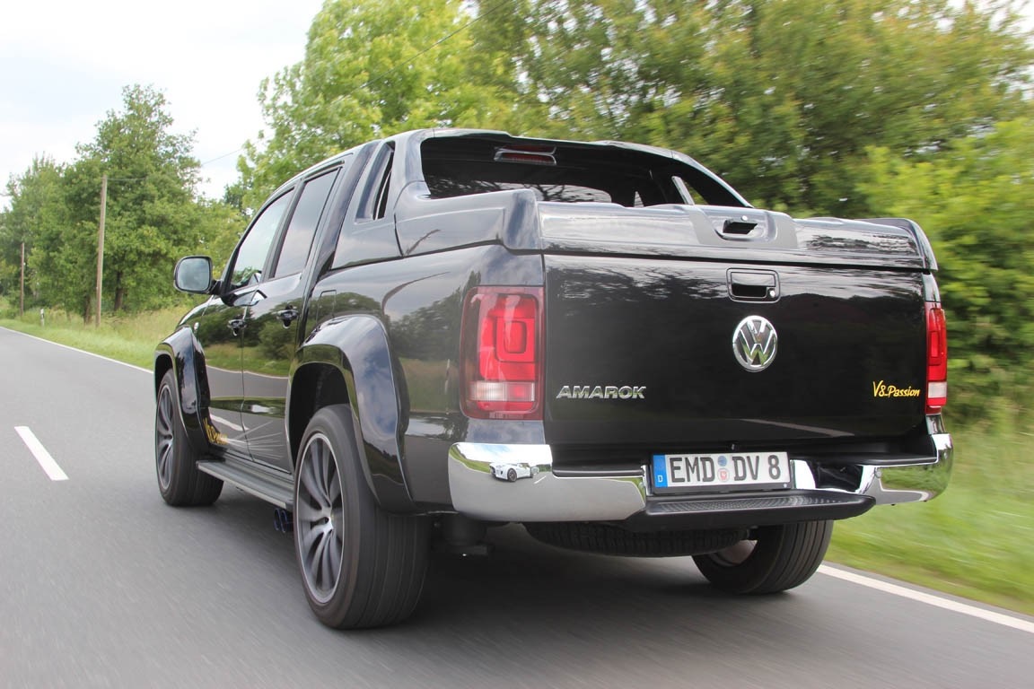 Black Volkswagen Amarok pickup truck driving on a road HD Wallpaper