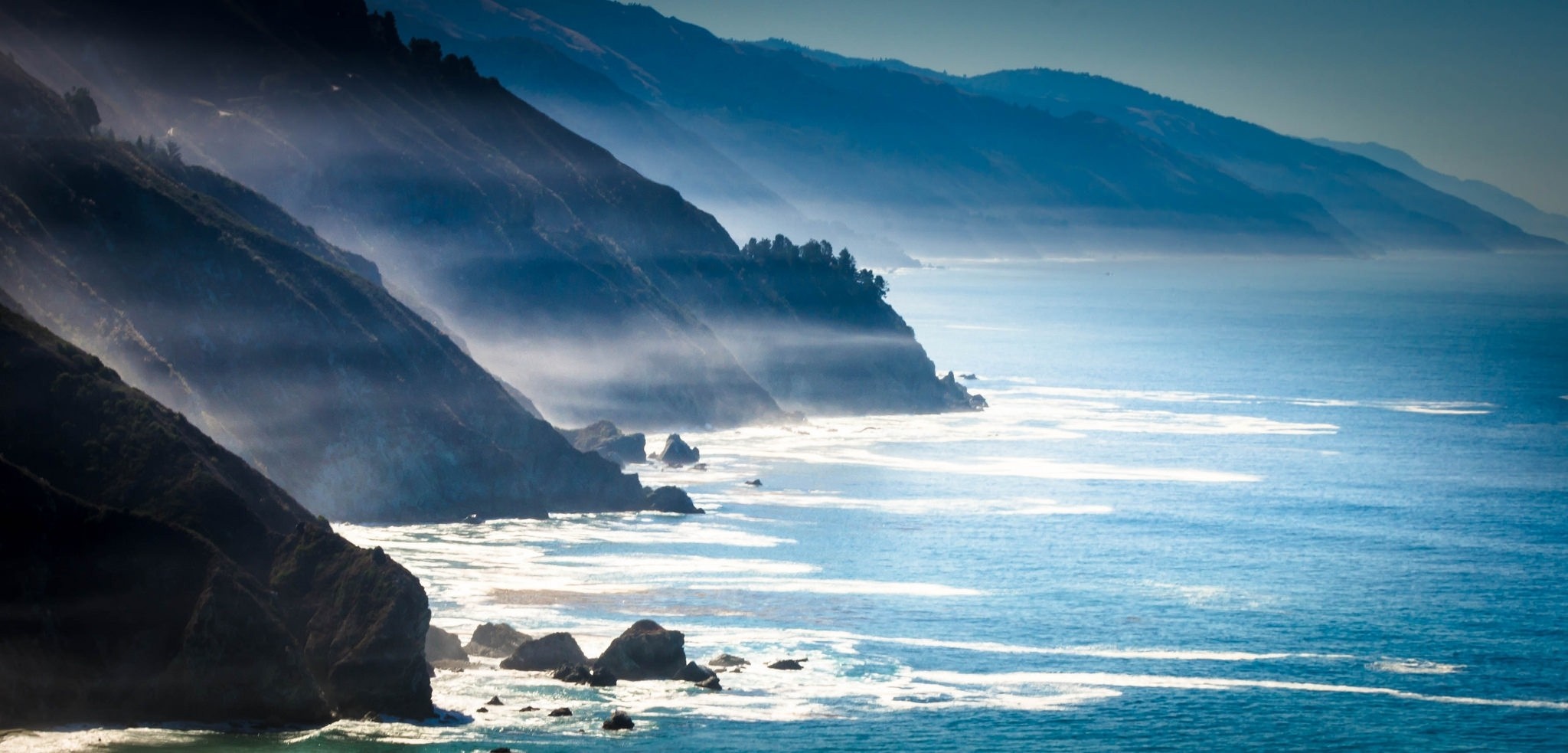 Misty Coastline with Mountains and Ocean Waves HD Wallpaper
