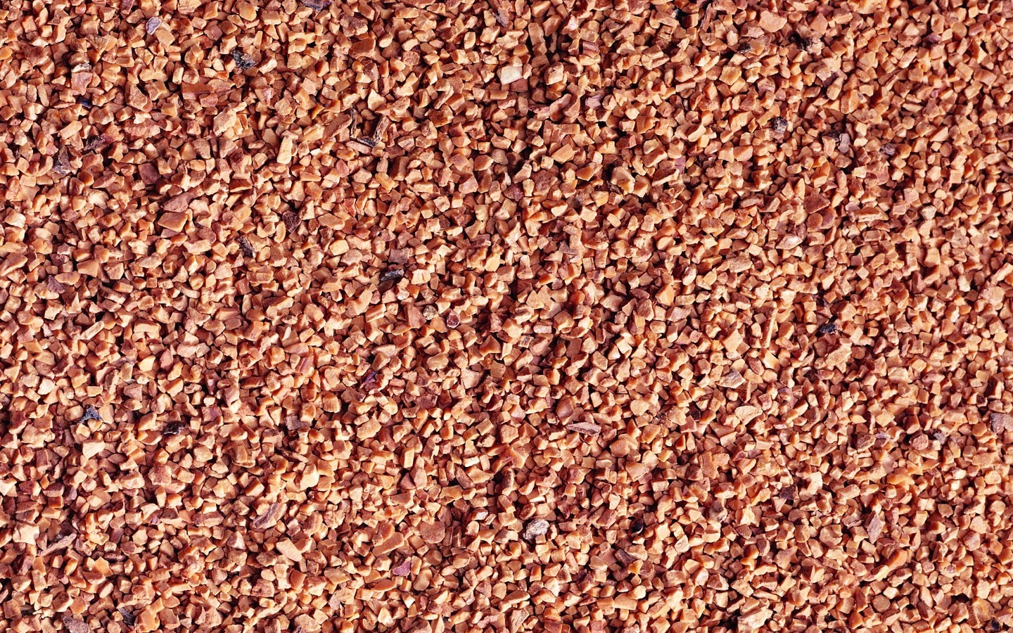 Close-up of small reddish-brown granular material HD Wallpaper