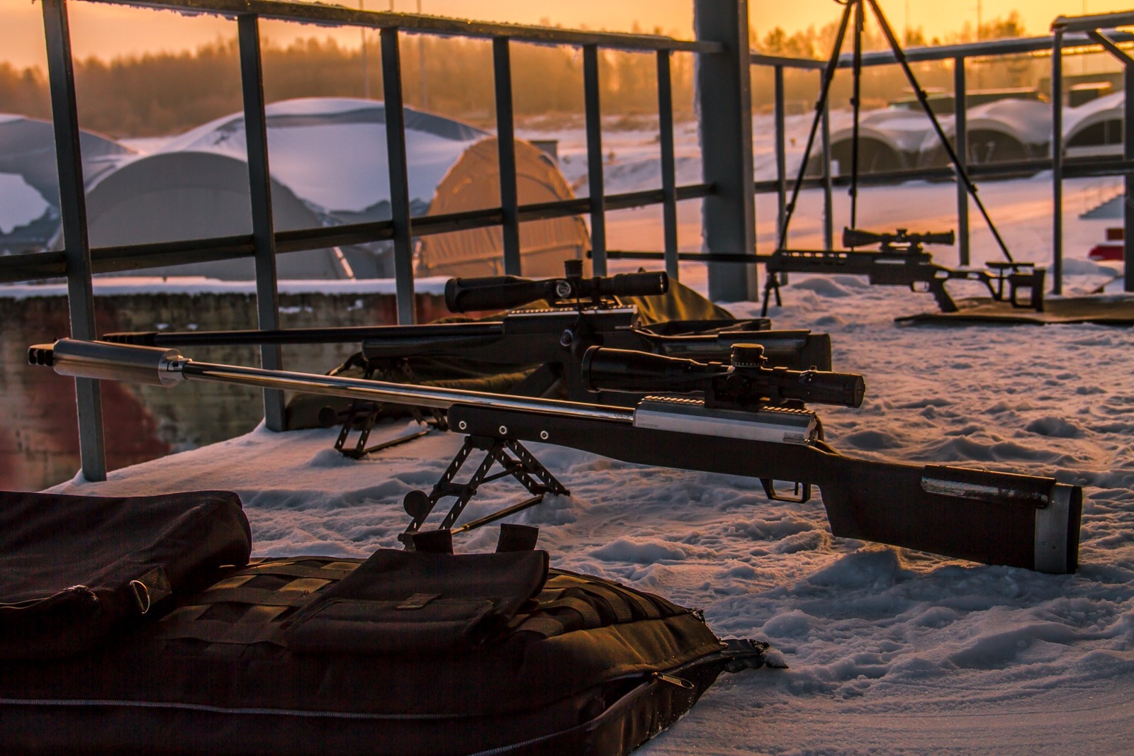 Sniper rifles on snow at sunset HD Wallpaper