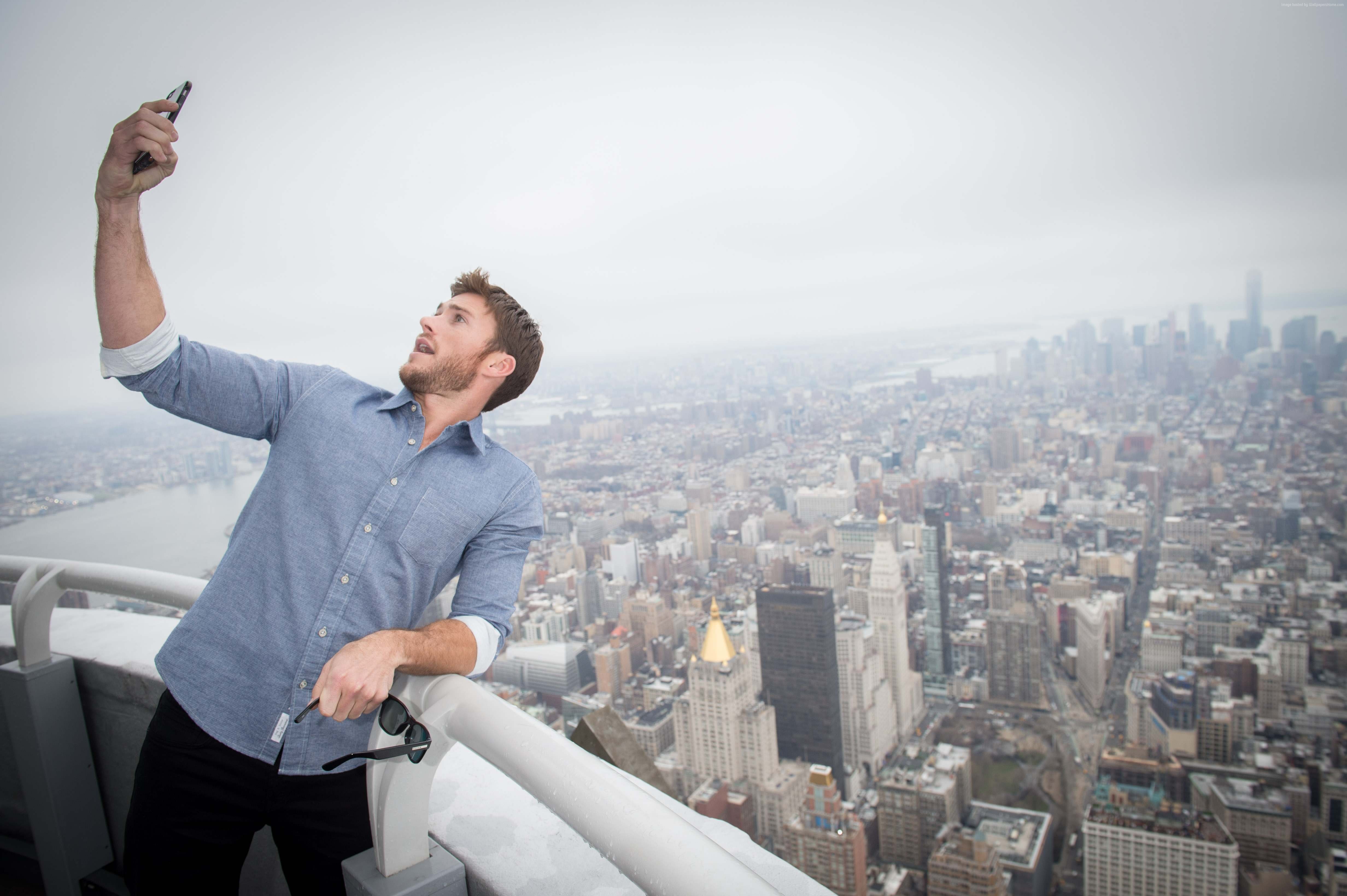 Scott Eastwood taking a selfie on a skyscraper HD Wallpaper