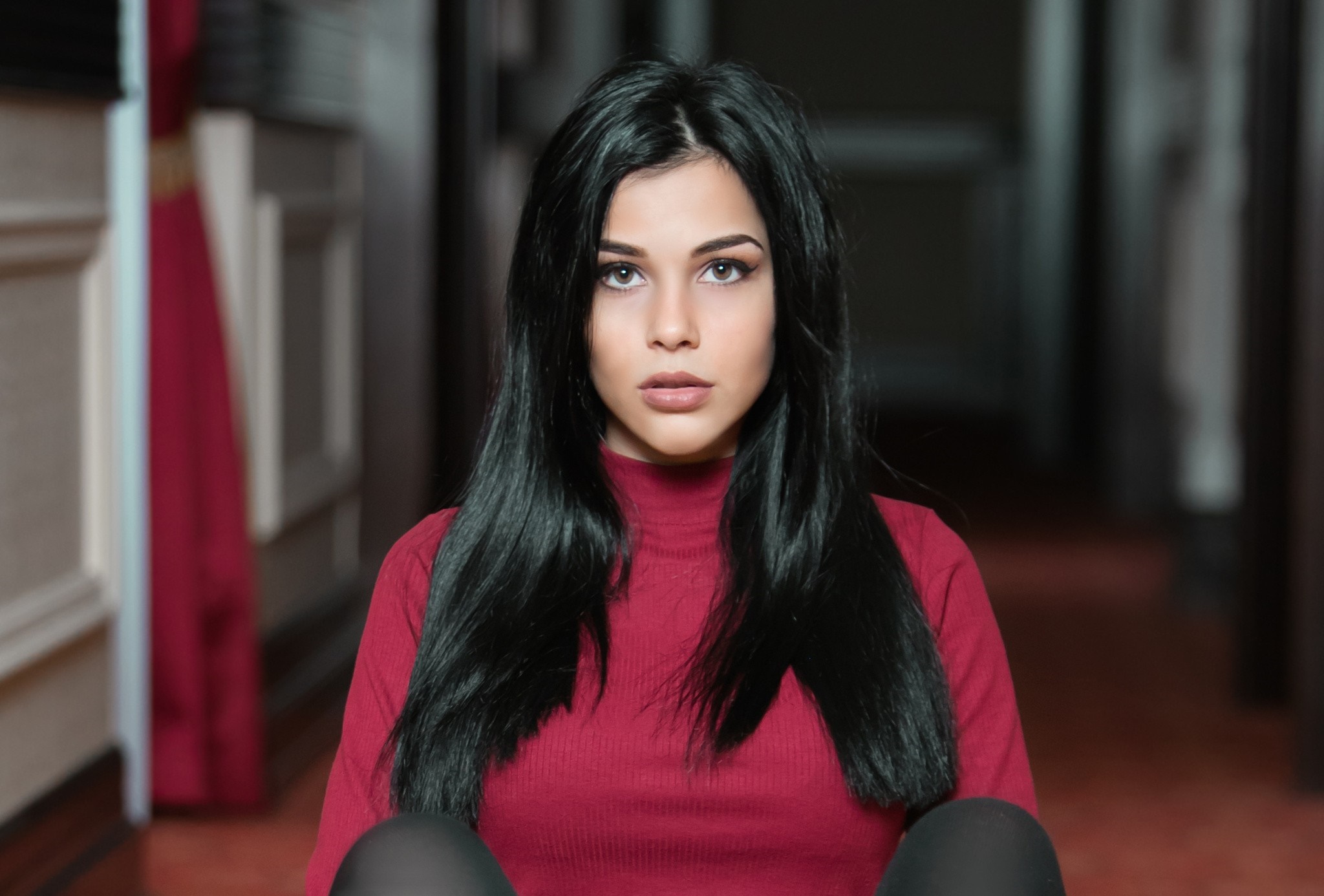 Woman with long black hair wearing a red turtleneck HD Wallpaper
