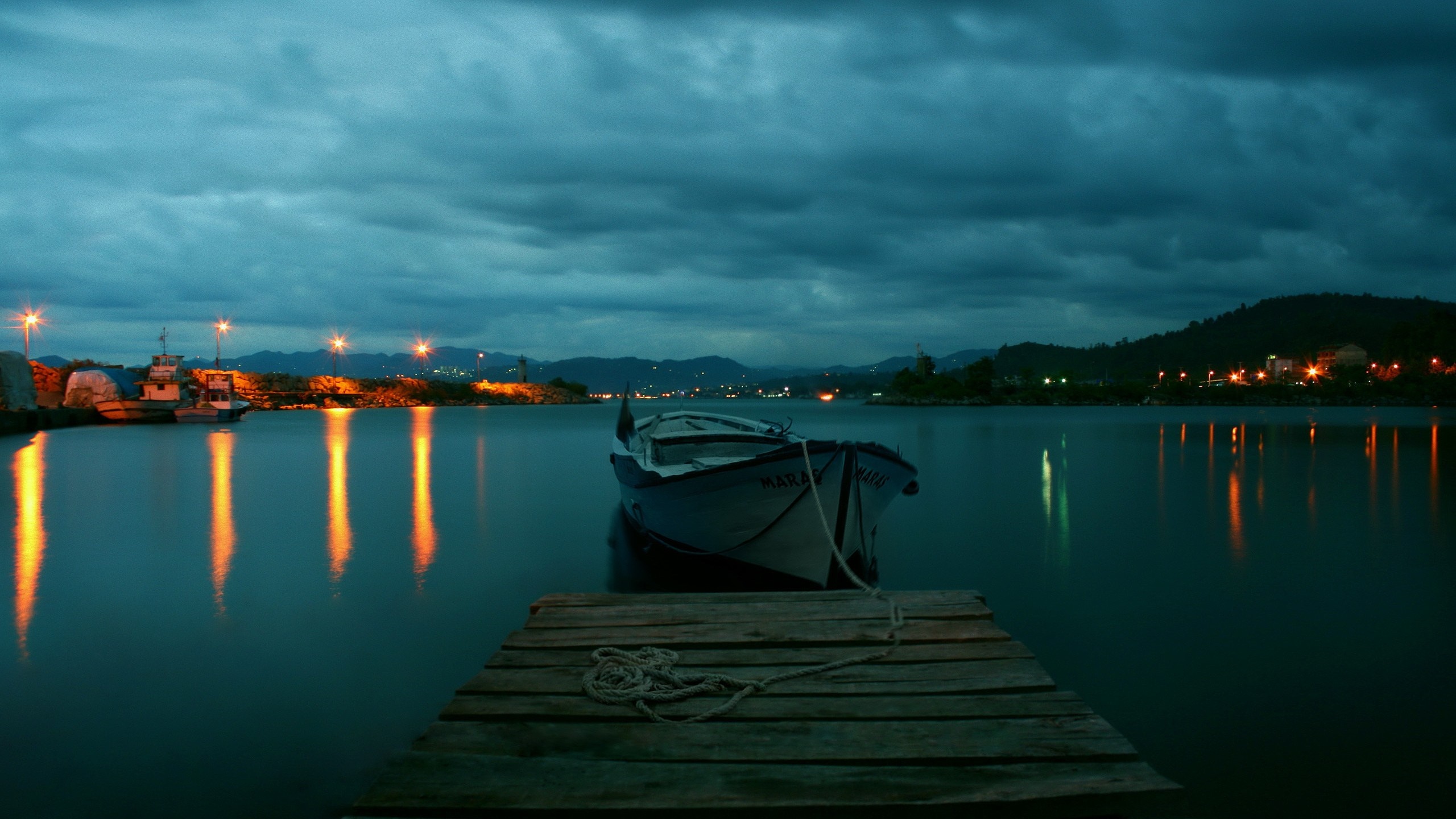 Boat docked at pier on a cloudy evening HD Wallpaper
