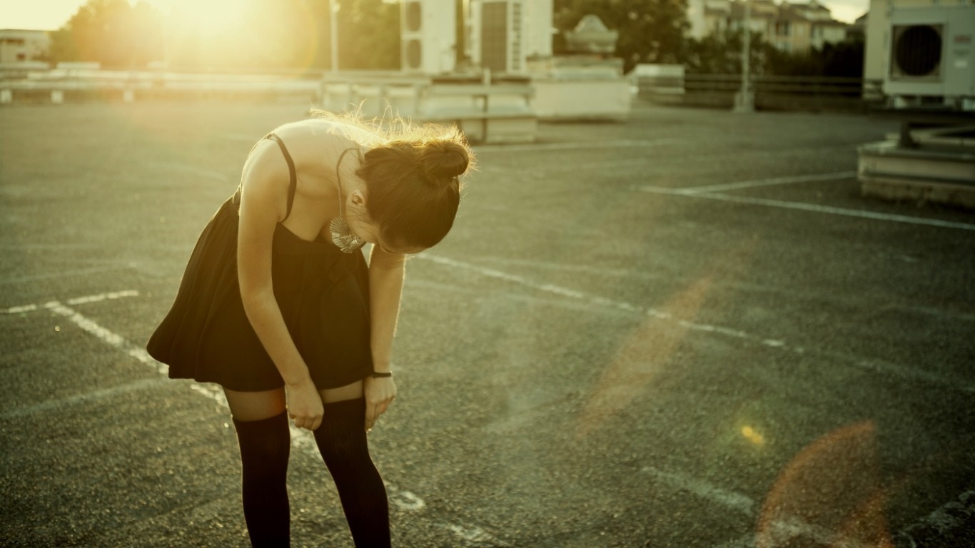 Woman in black dress on rooftop at sunrise HD Wallpaper