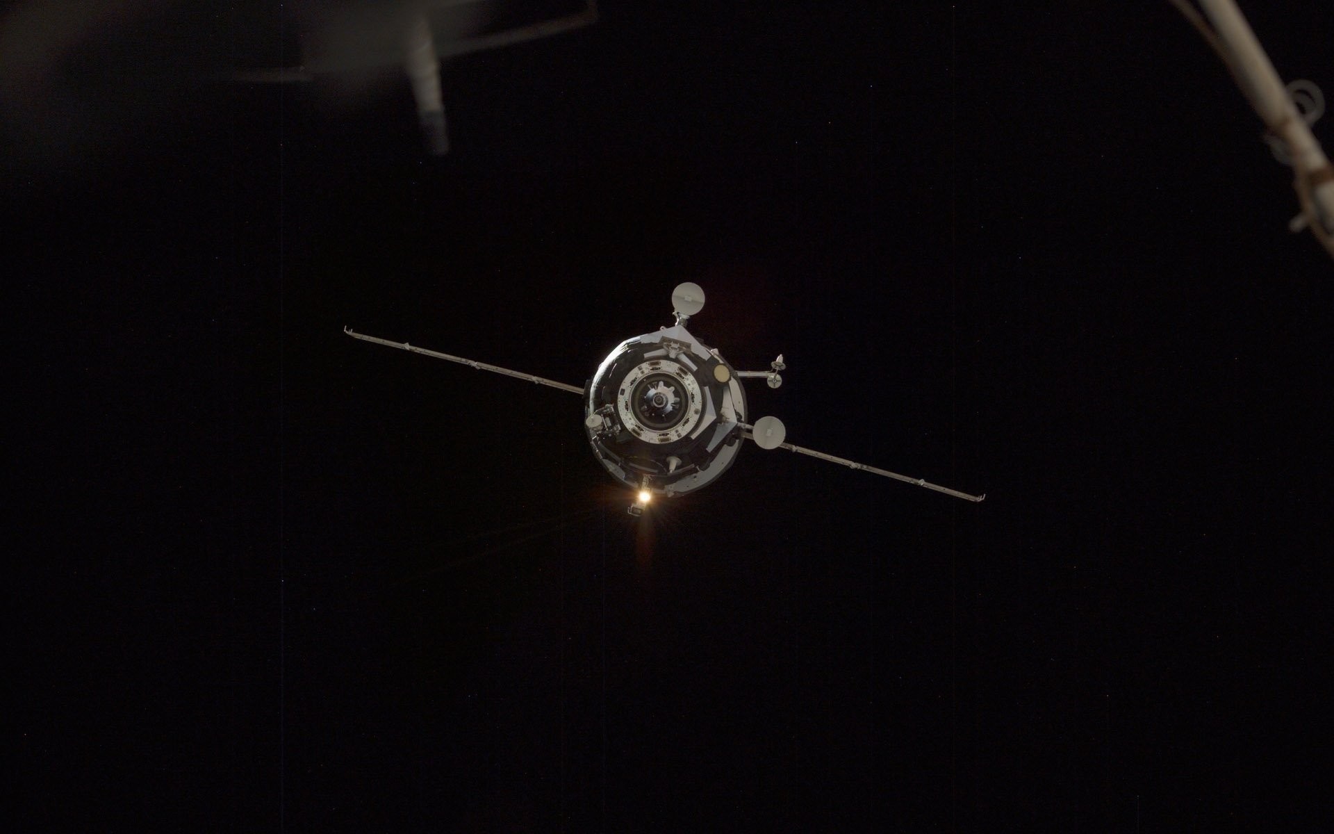 Spacecraft approaching the International Space Station at night HD Wallpaper