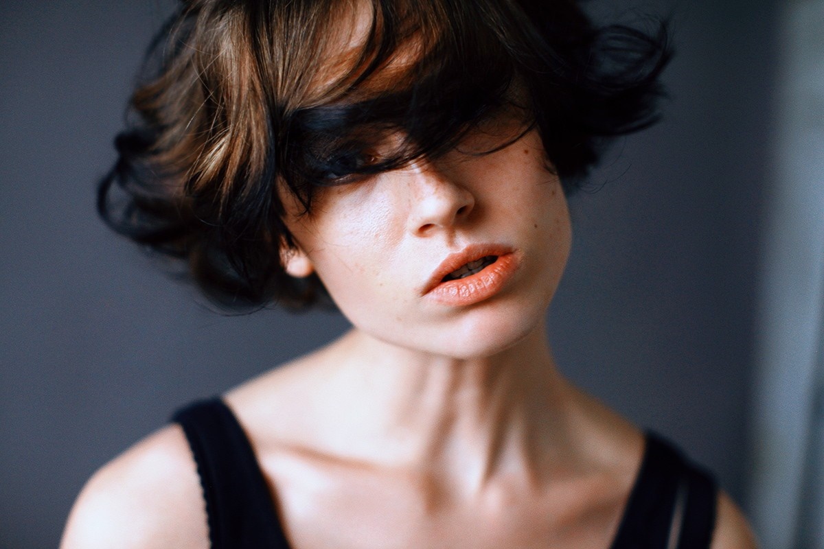 Woman with short, dark and brown hair covering her face HD Wallpaper