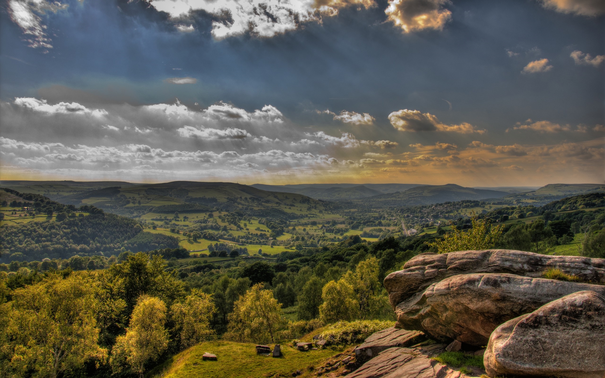 Scenic valley with rolling hills and dramatic clouds HD Wallpaper