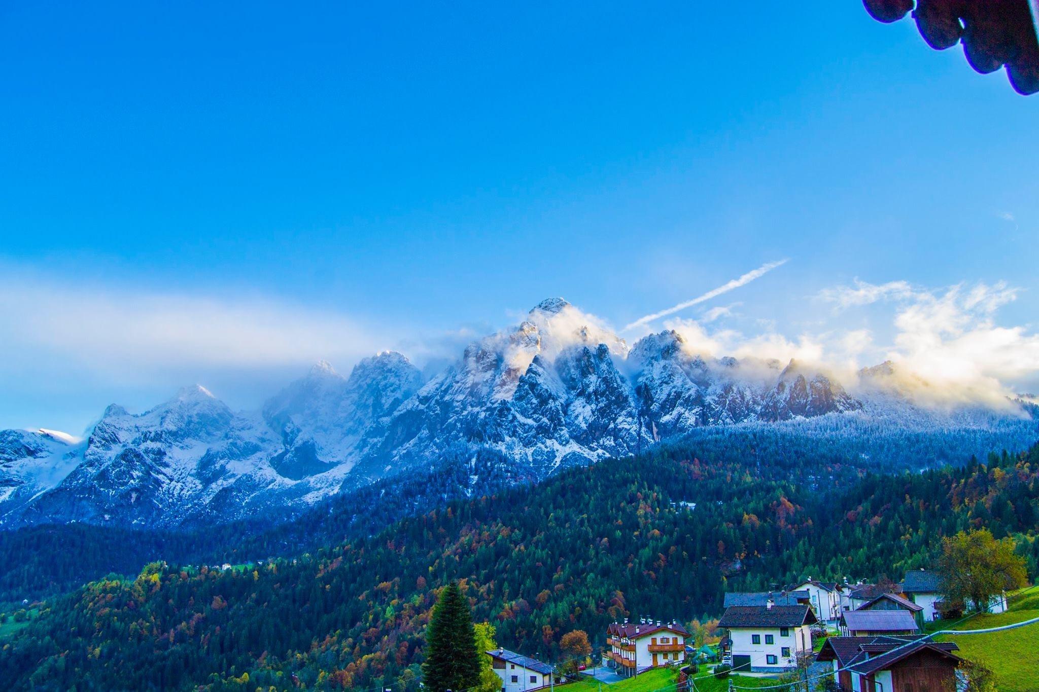 Snow-capped mountains above a village in autumn HD Wallpaper