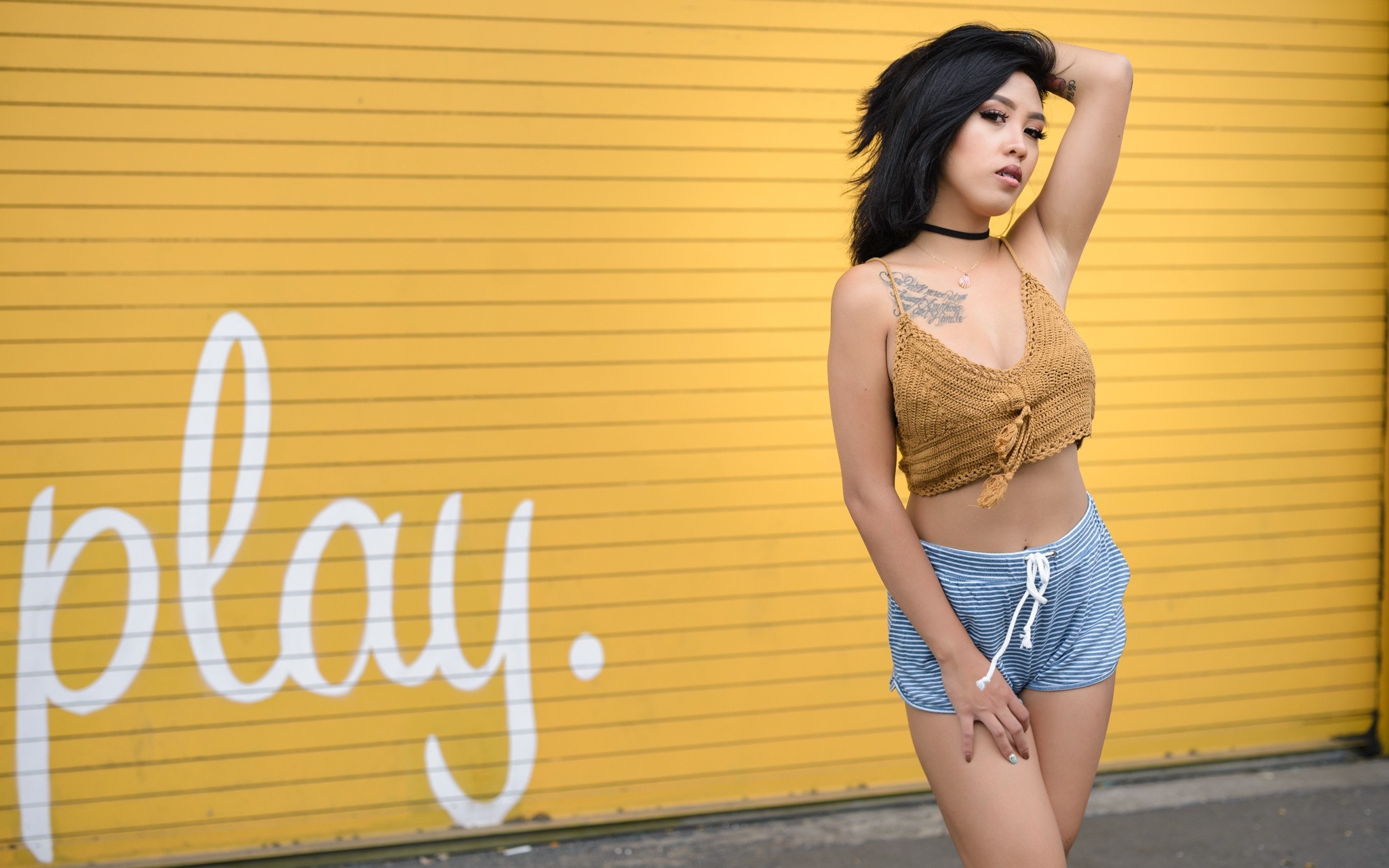 Woman with tattoos in a yellow wall background HD Wallpaper