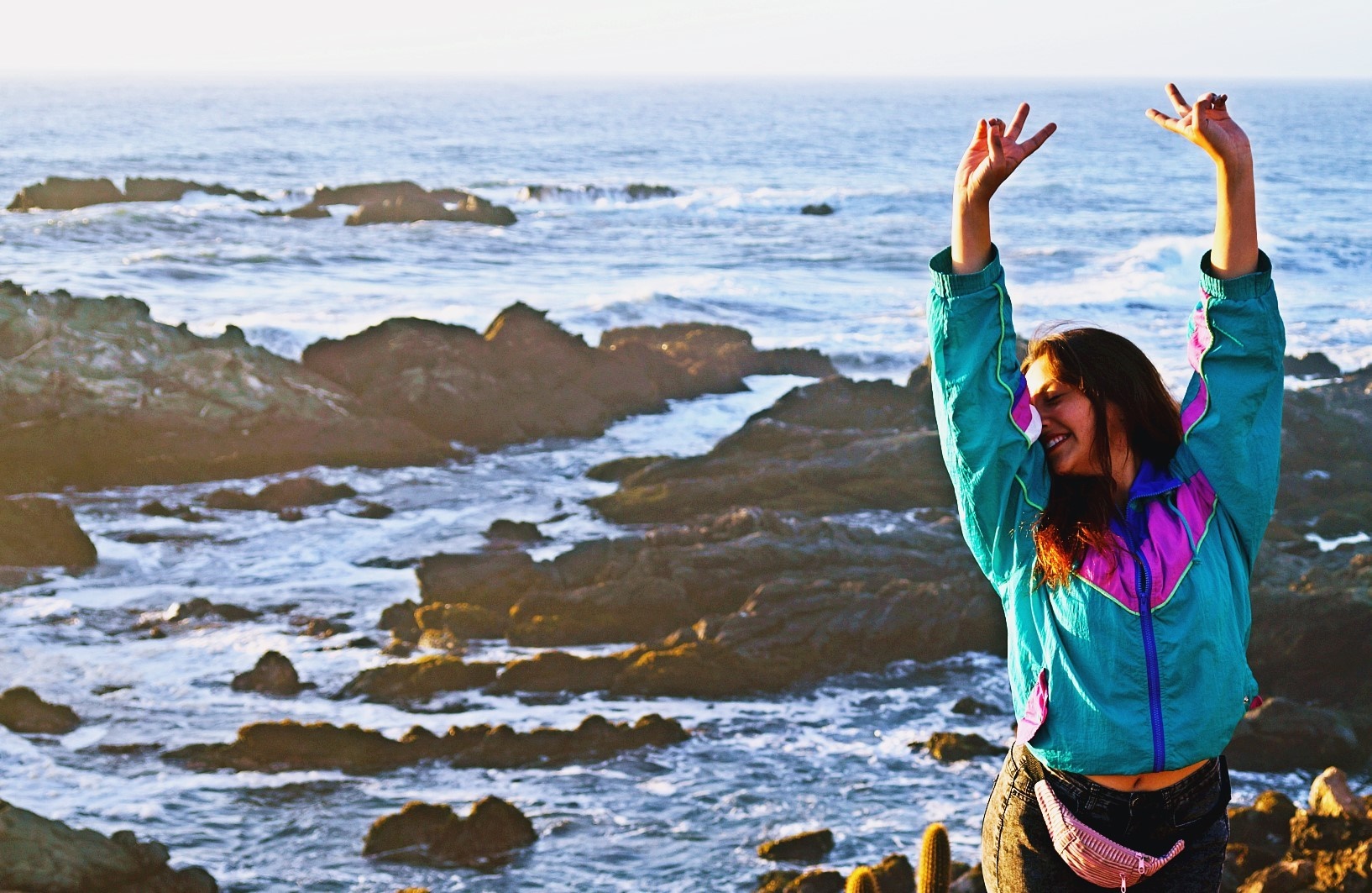 Woman with arms raised by the sea HD Wallpaper