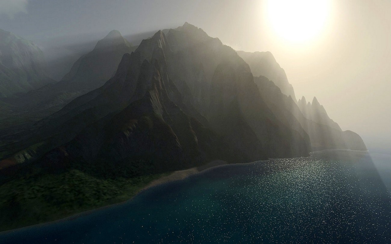 Misty mountains by the sea at sunrise with sun rays HD Wallpaper