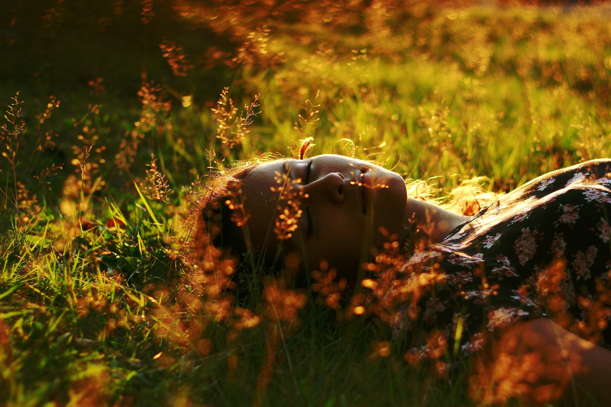 Woman lying in grass with sunlight HD Wallpaper